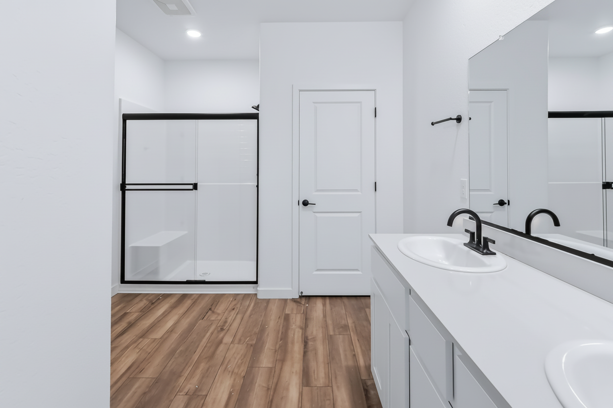 A bathroom with white cabinets.