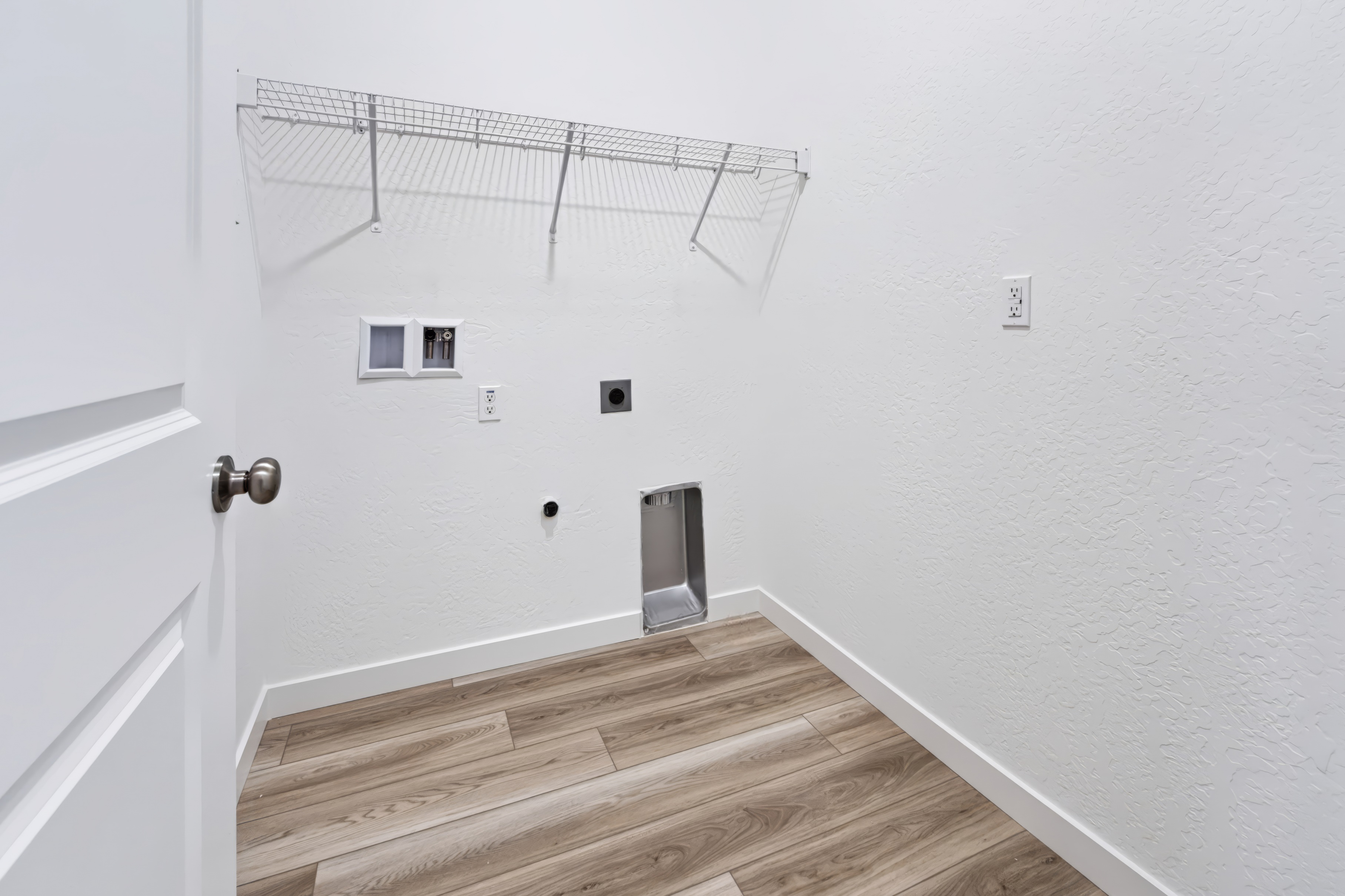 A room with a wood floor and a metal railing.