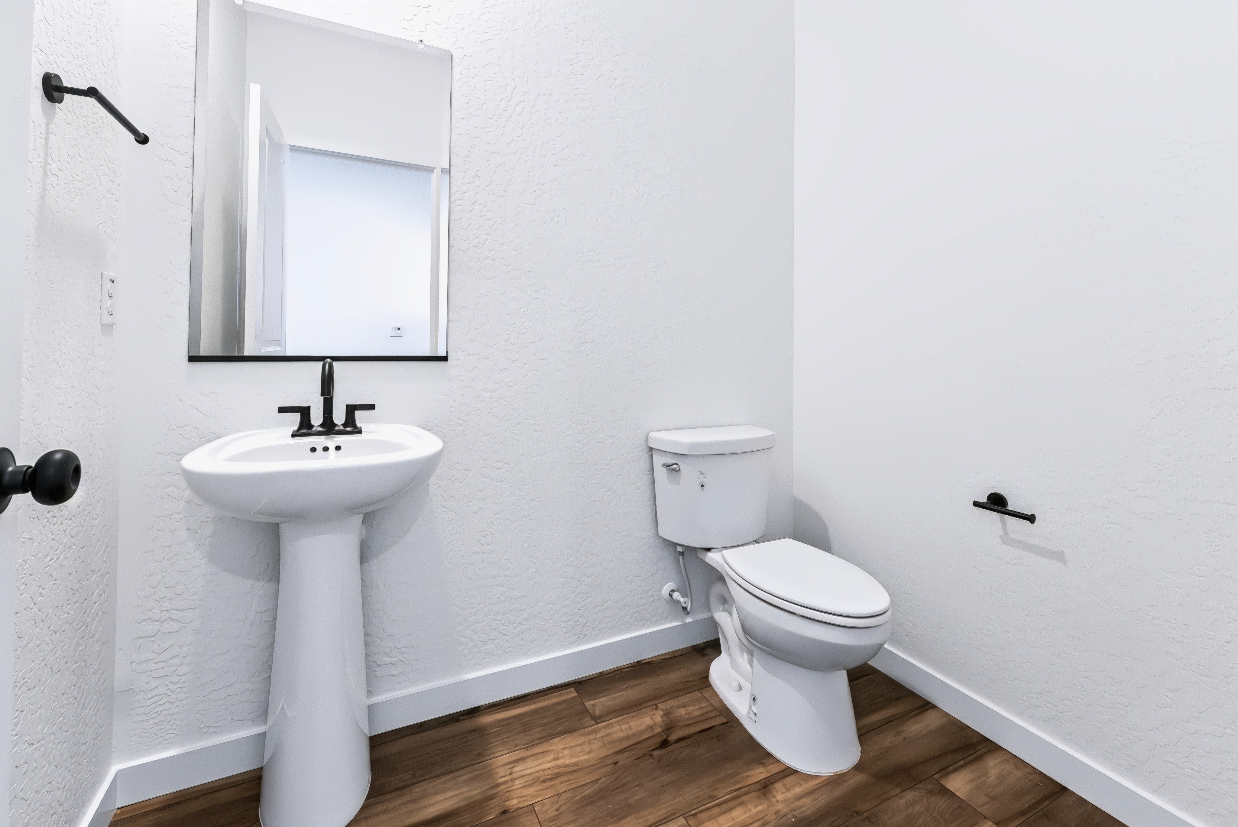 A bathroom with a toilet and sink.