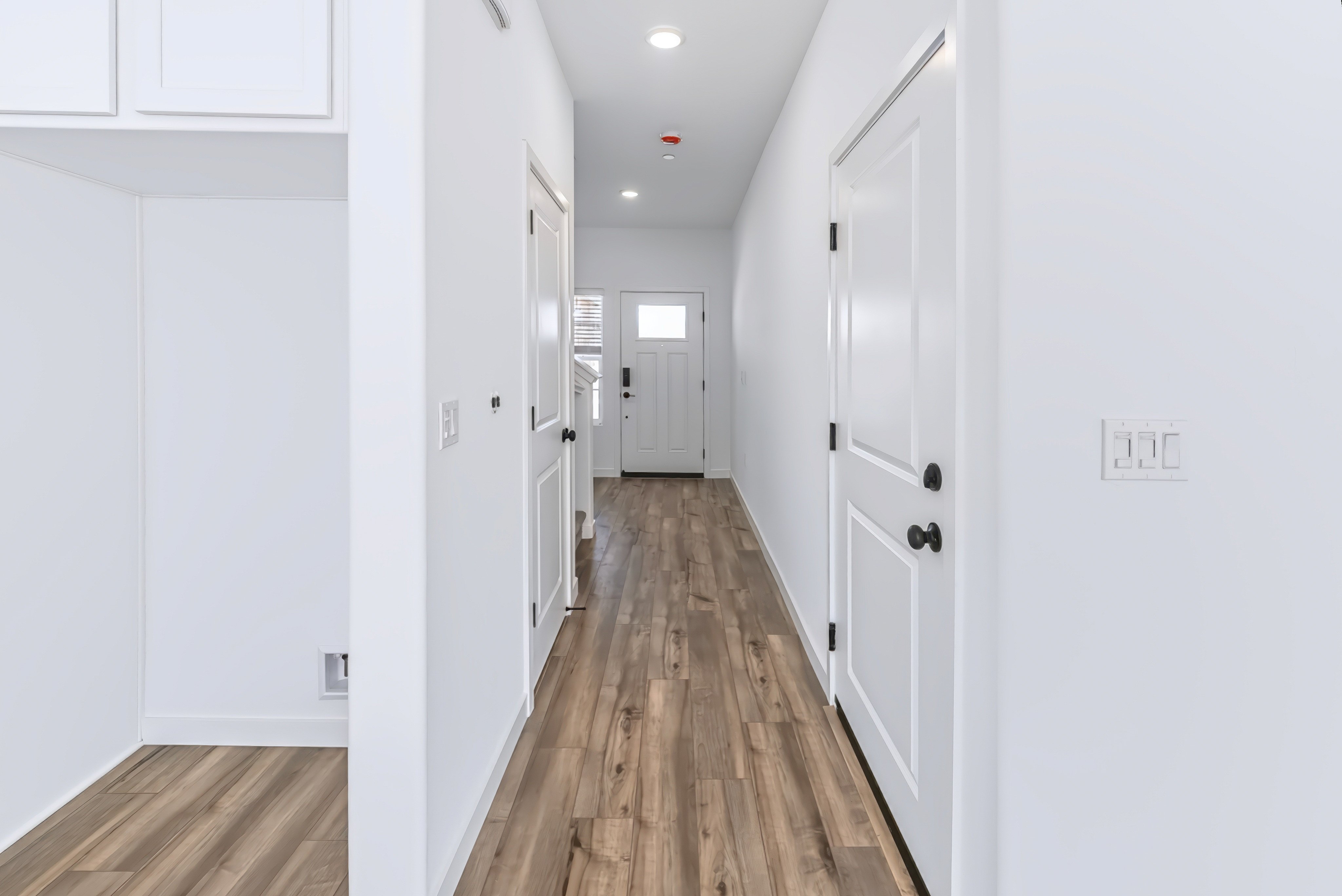 A hallway with white walls.