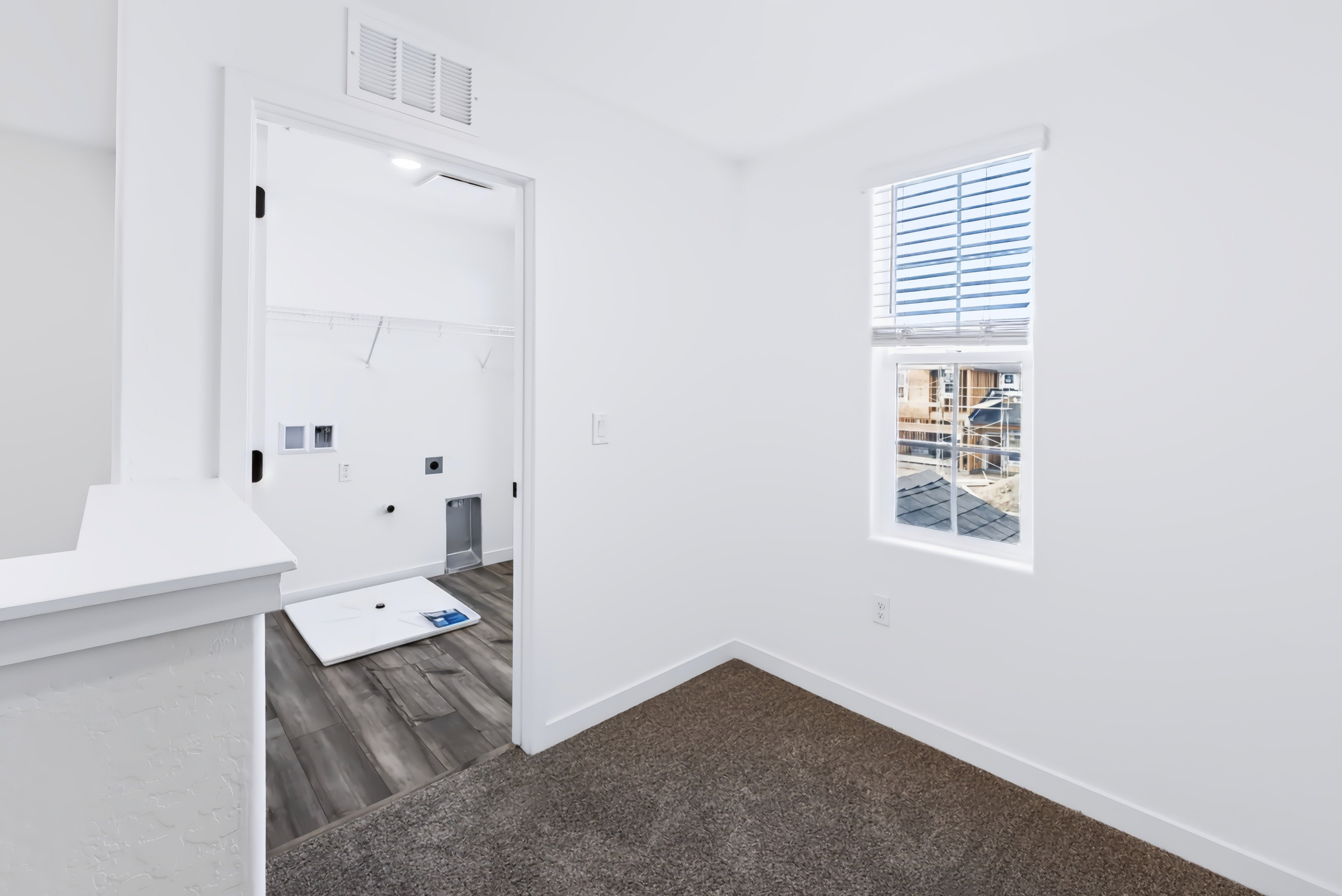 A room with a window and a bench.