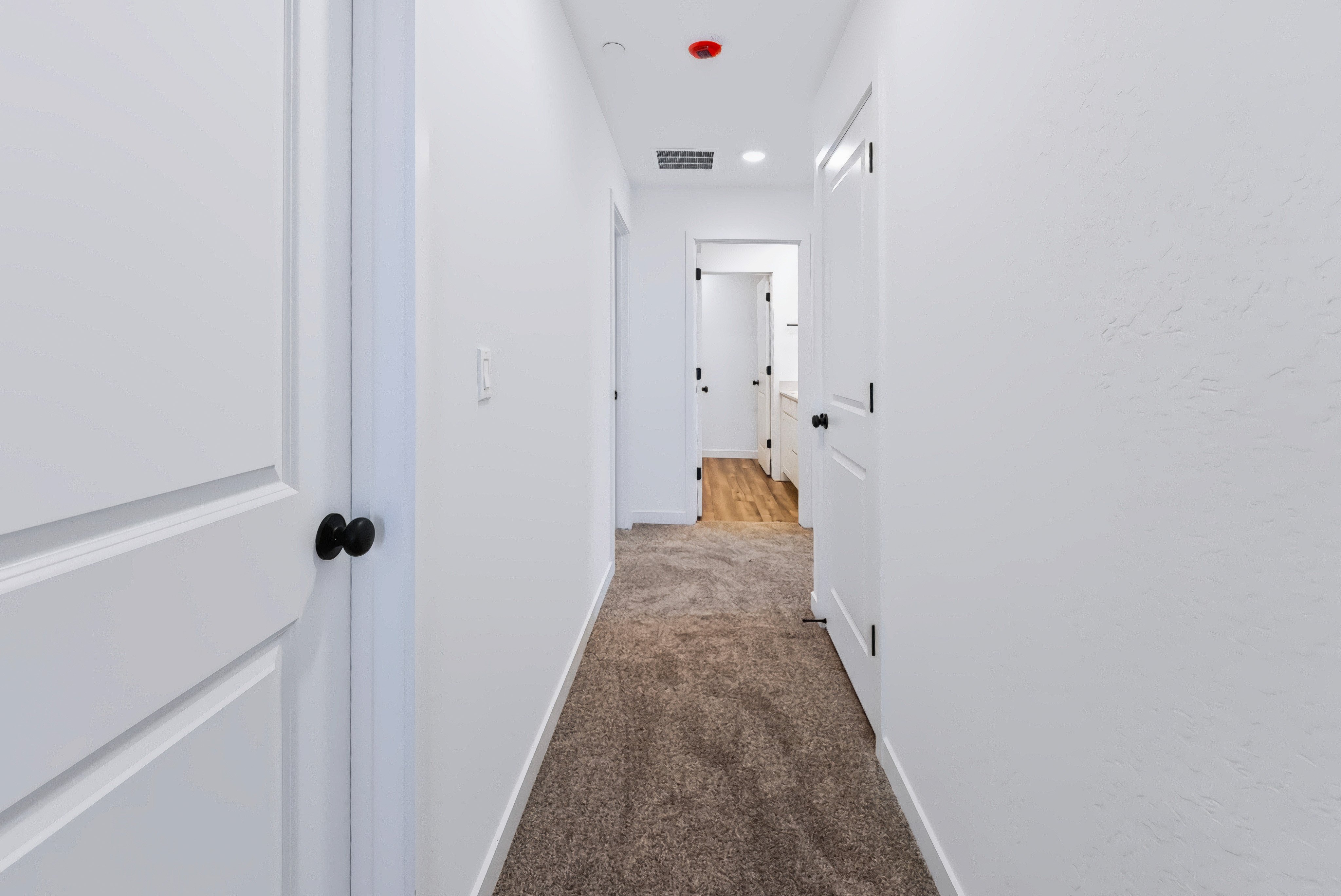 A hallway with white doors.
