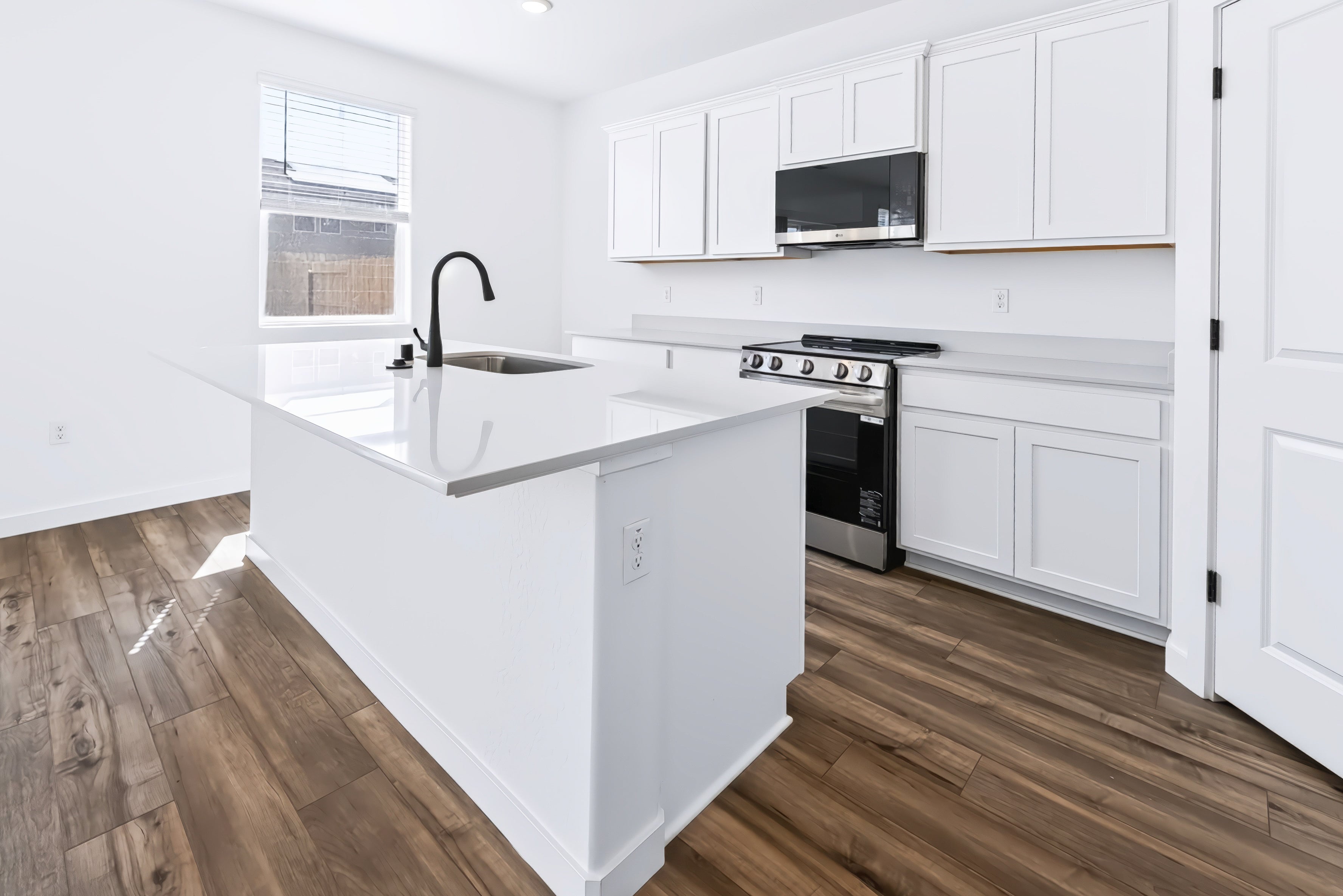 A kitchen with white cabinets.
