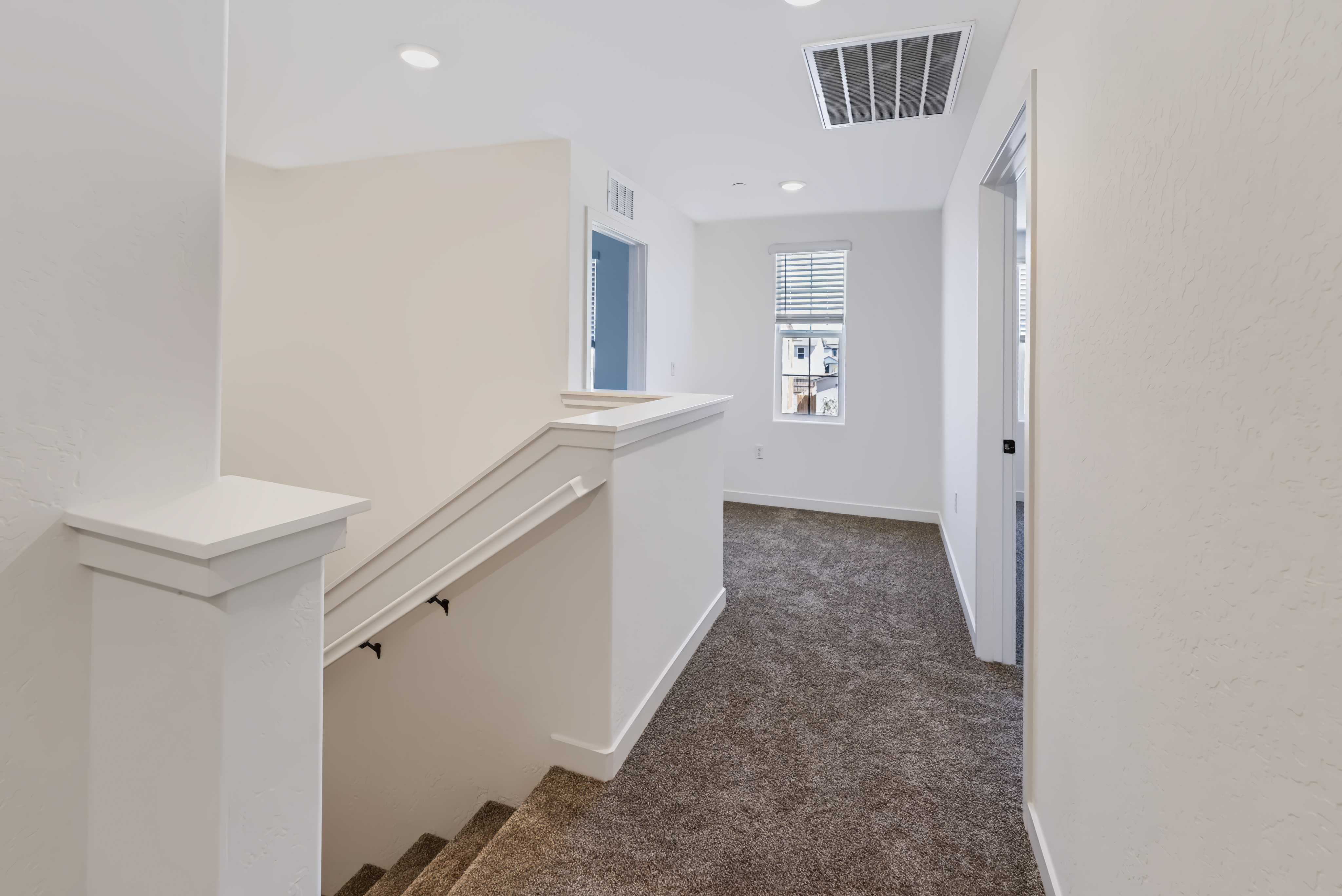 A hallway with white walls.
