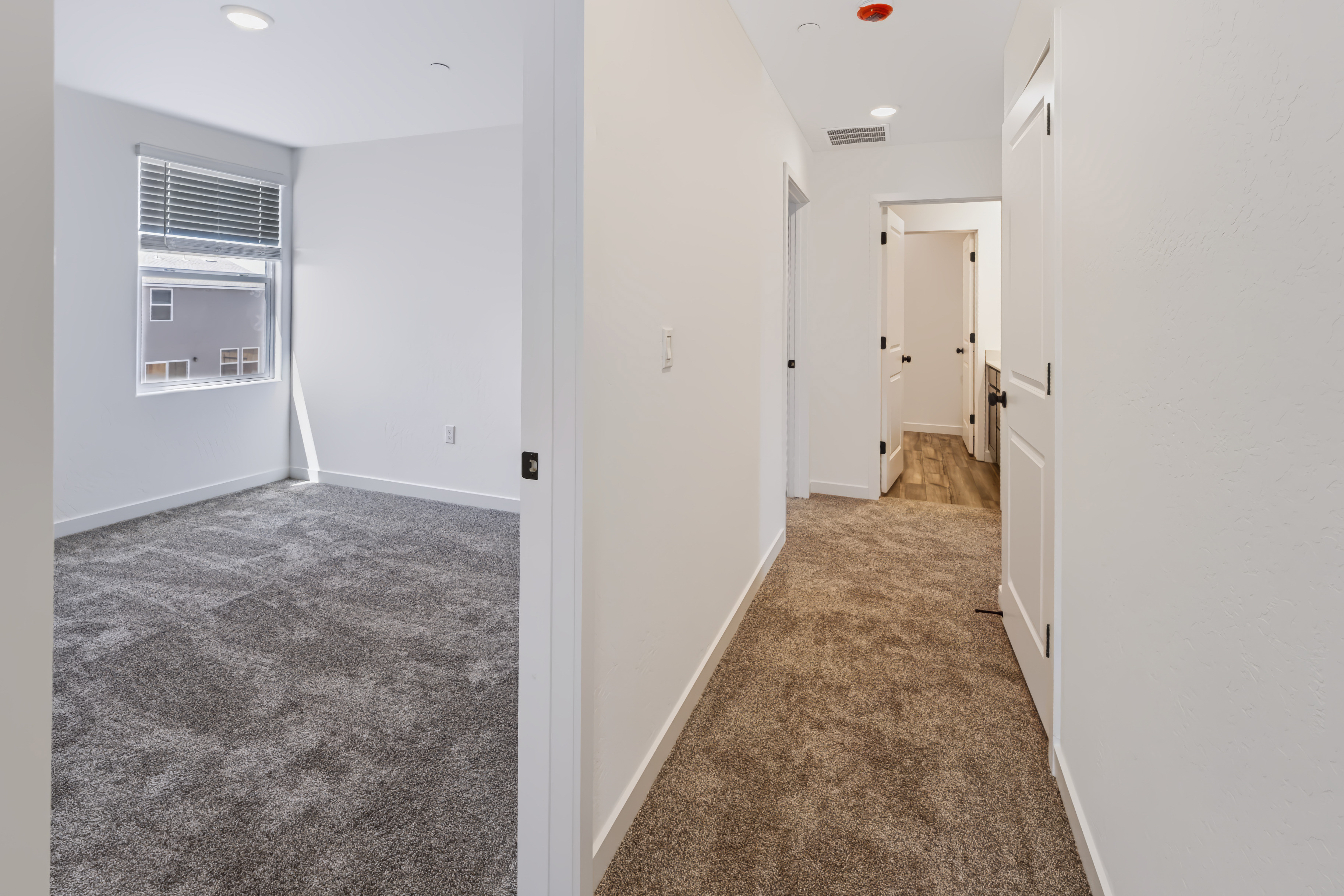A hallway with white walls.