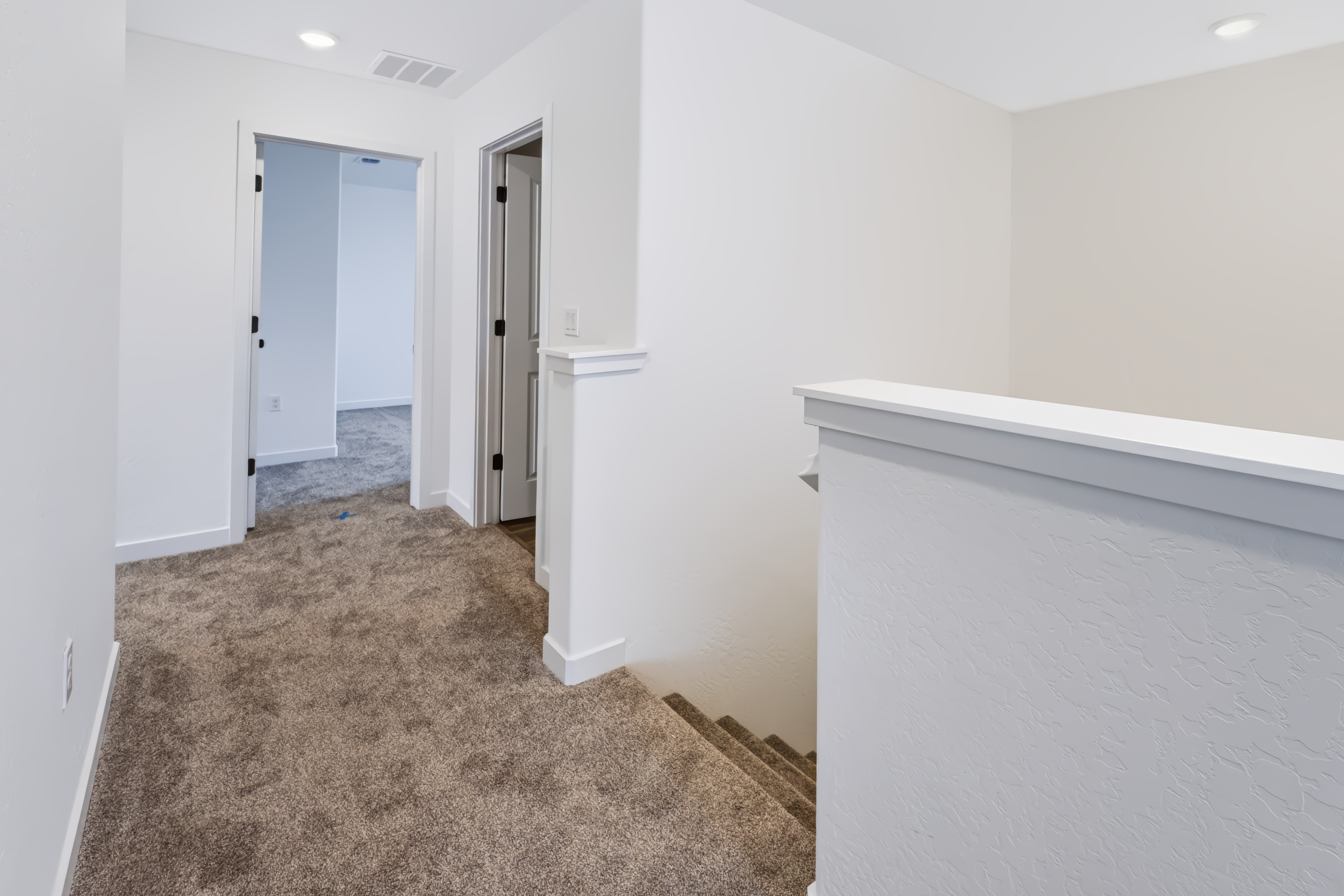A hallway with white walls.