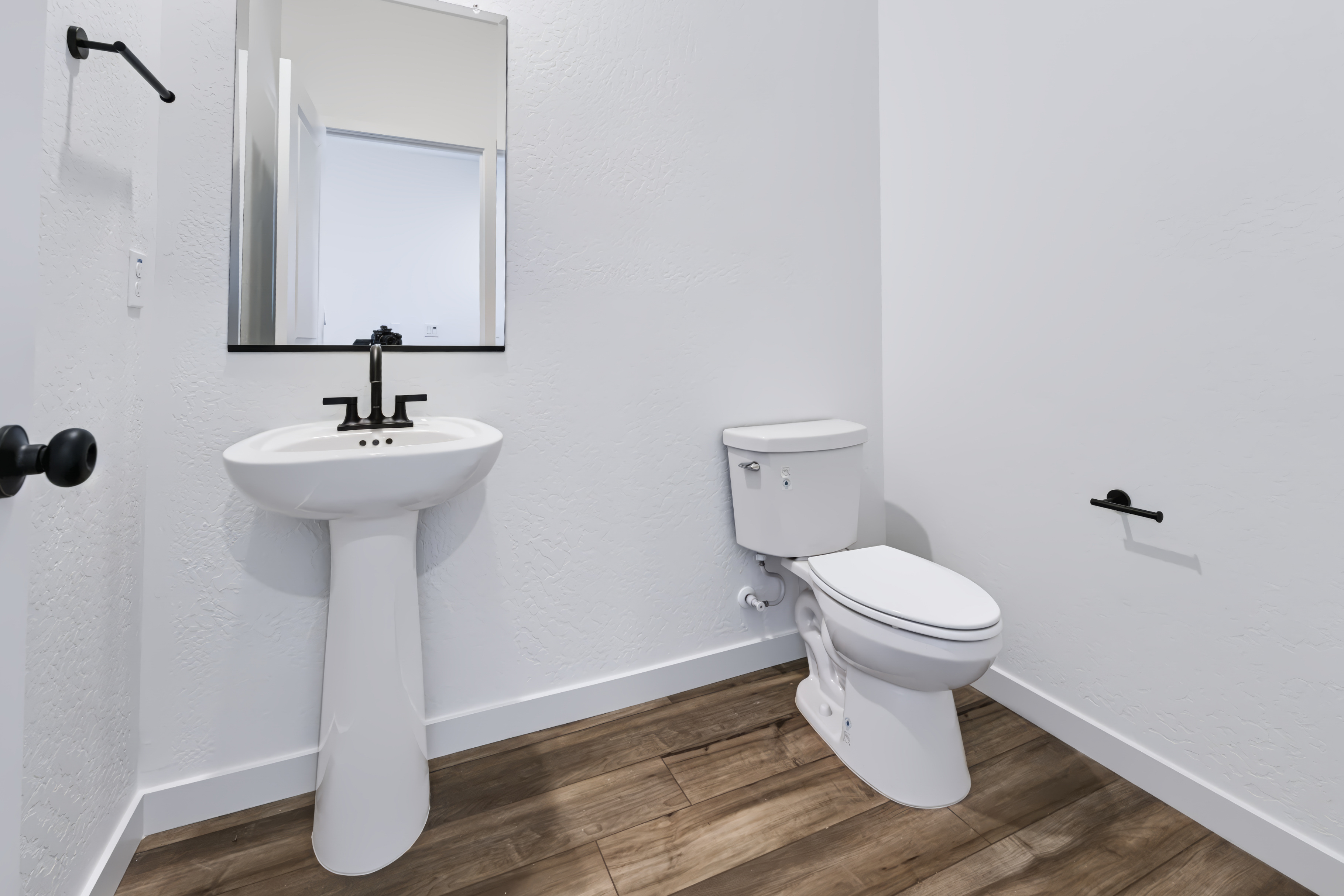 A bathroom with a toilet and sink.