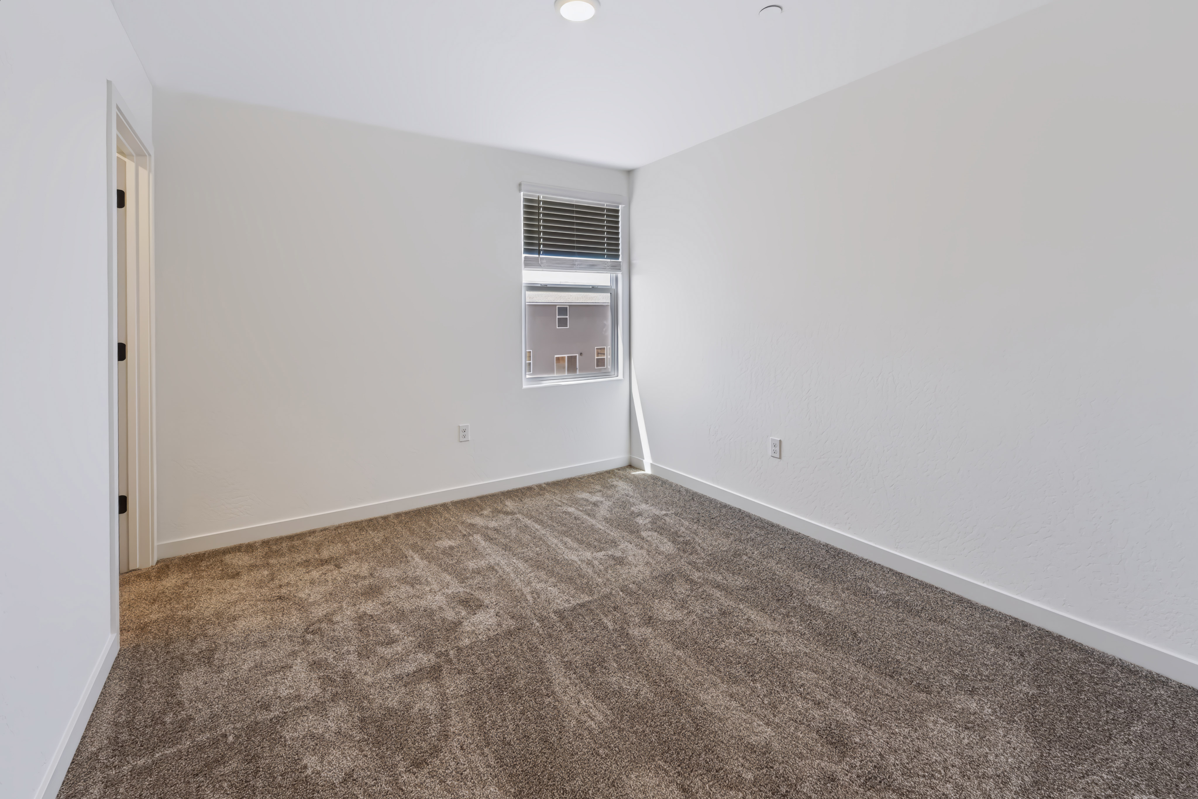 A room with carpet and a window.