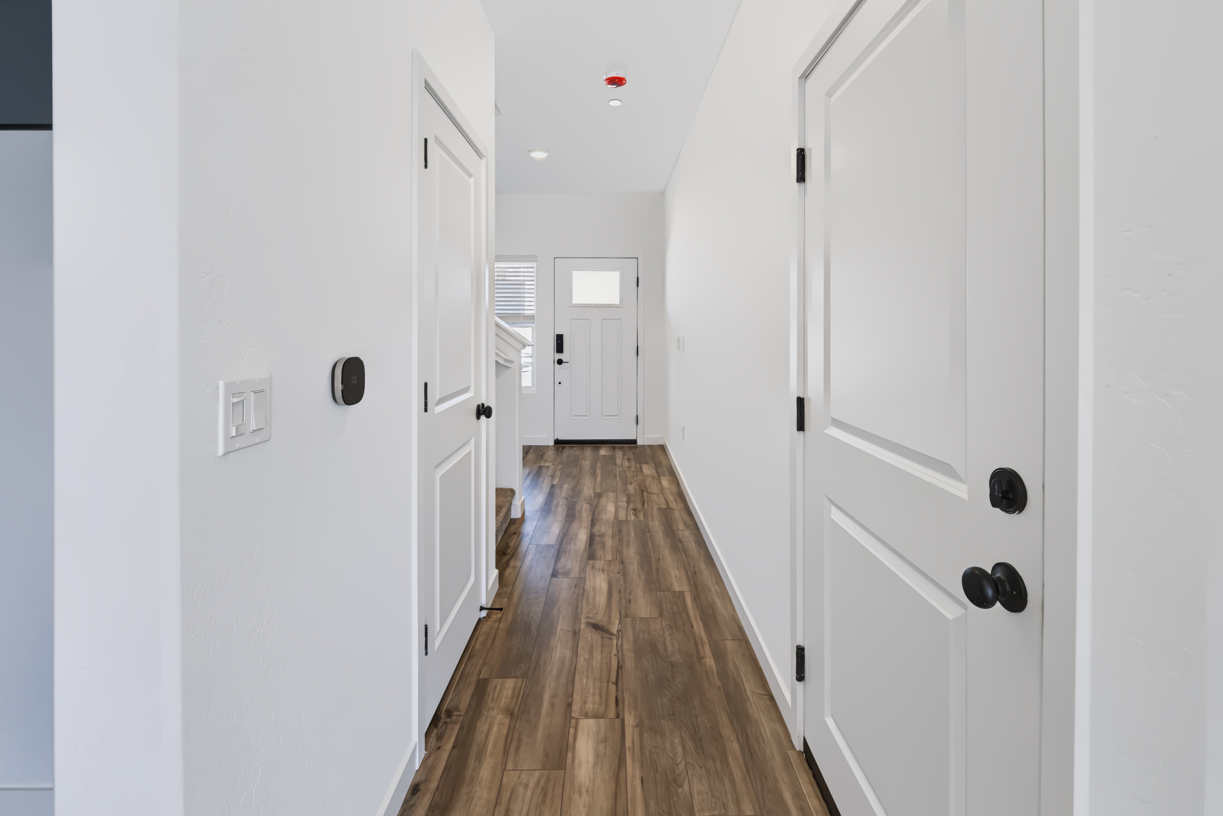 A hallway with white doors.