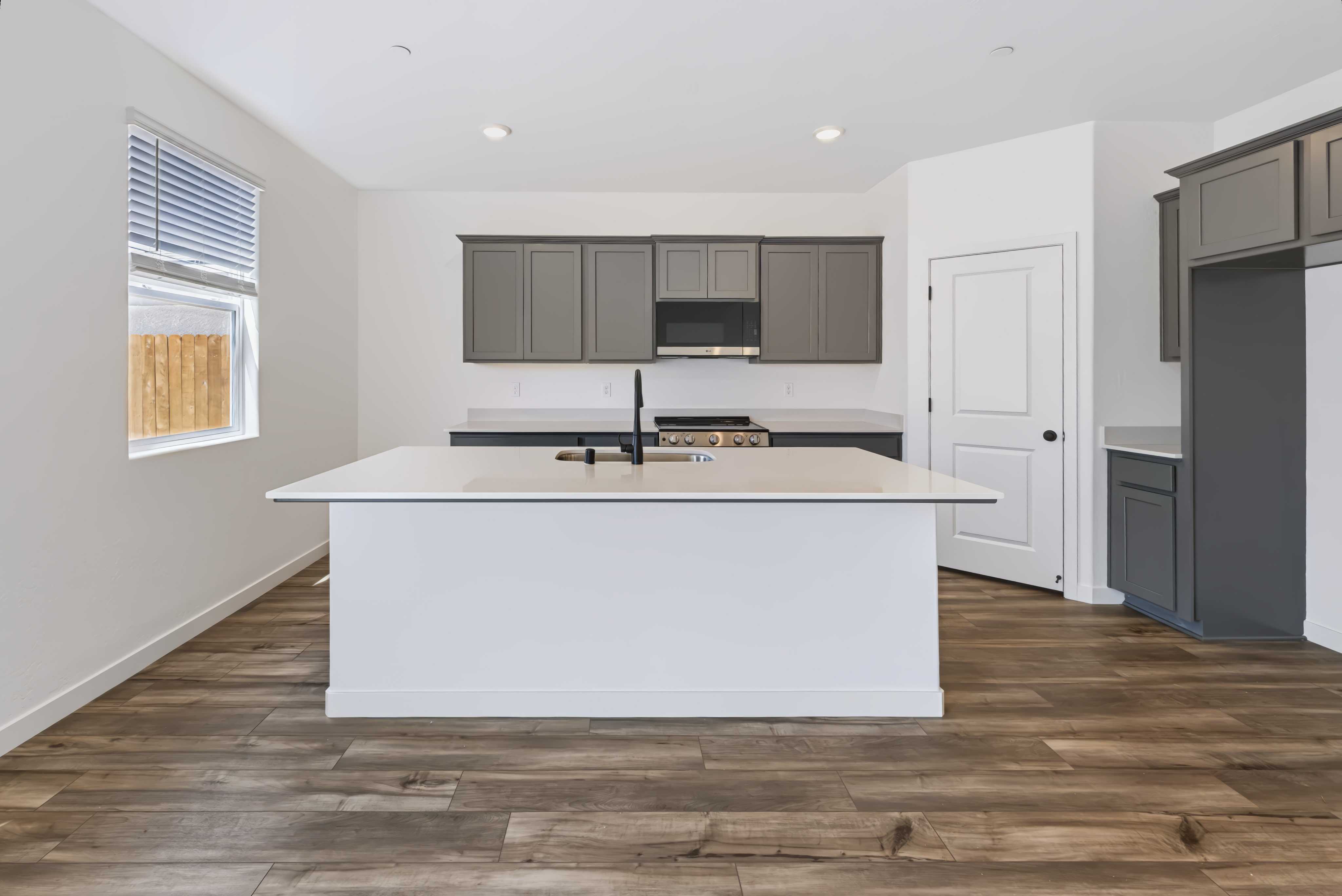 A kitchen with white cabinets.
