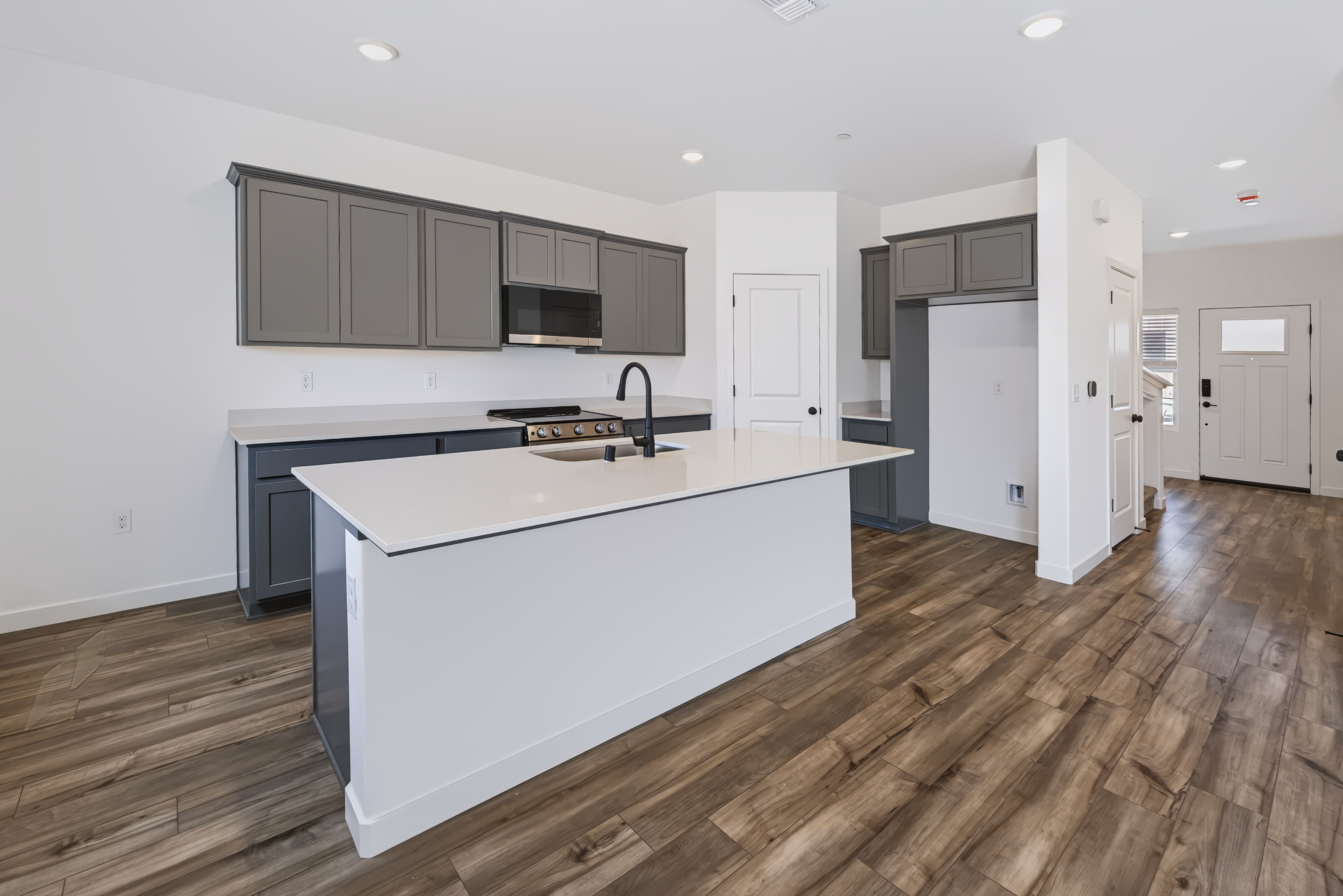 A kitchen with white cabinets.