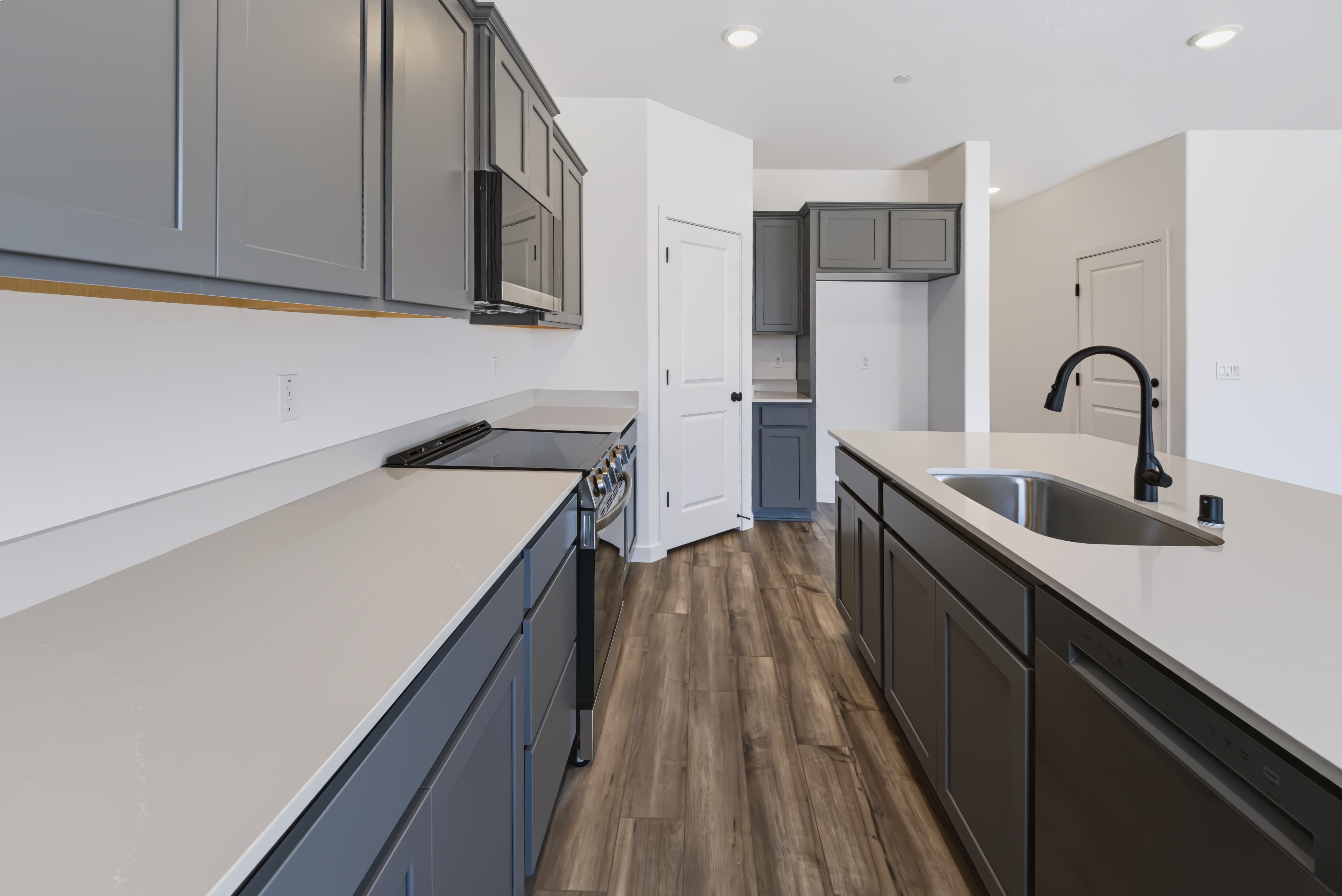 A kitchen with white cabinets.