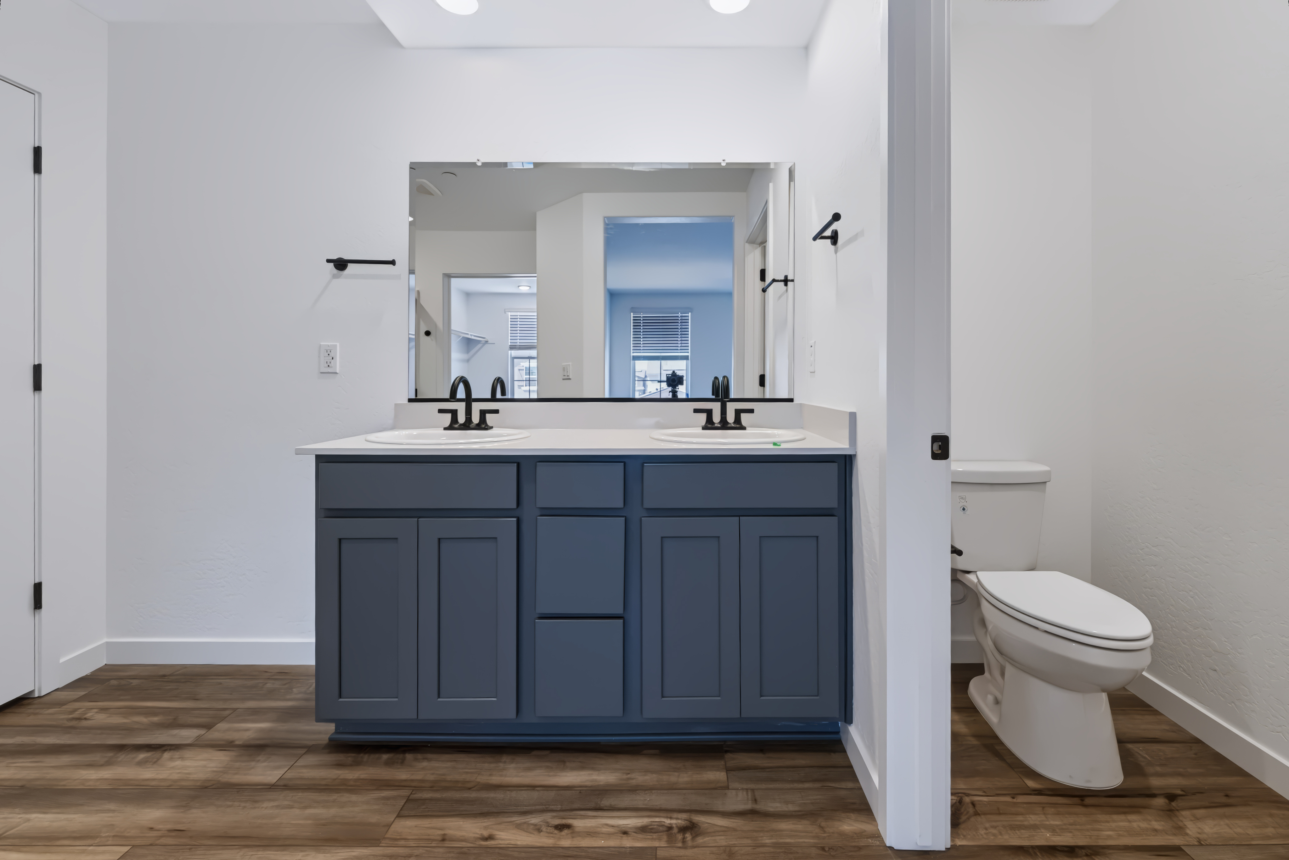 A bathroom with a blue cabinet.