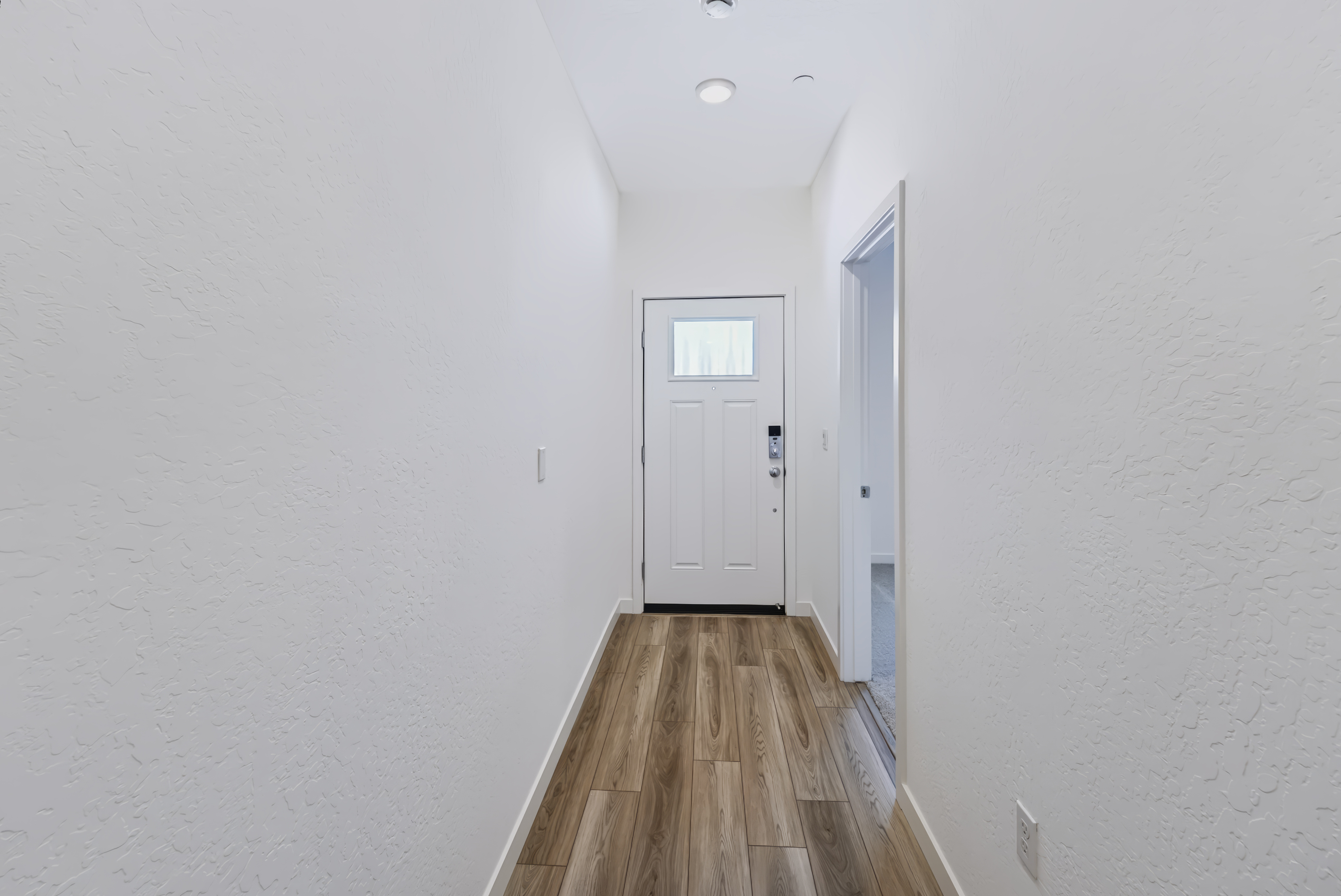 A hallway with white walls.