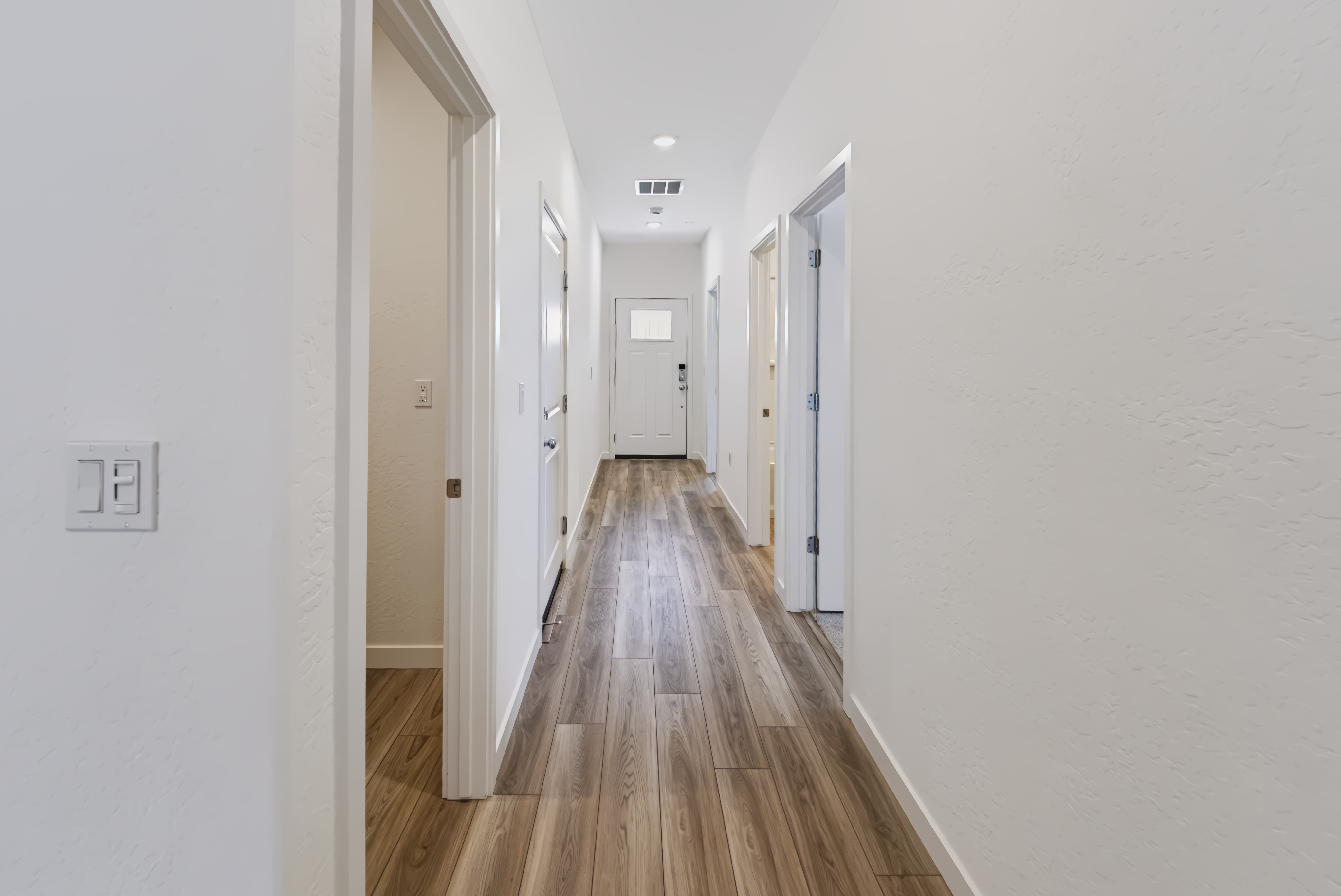 A long hallway with white walls.