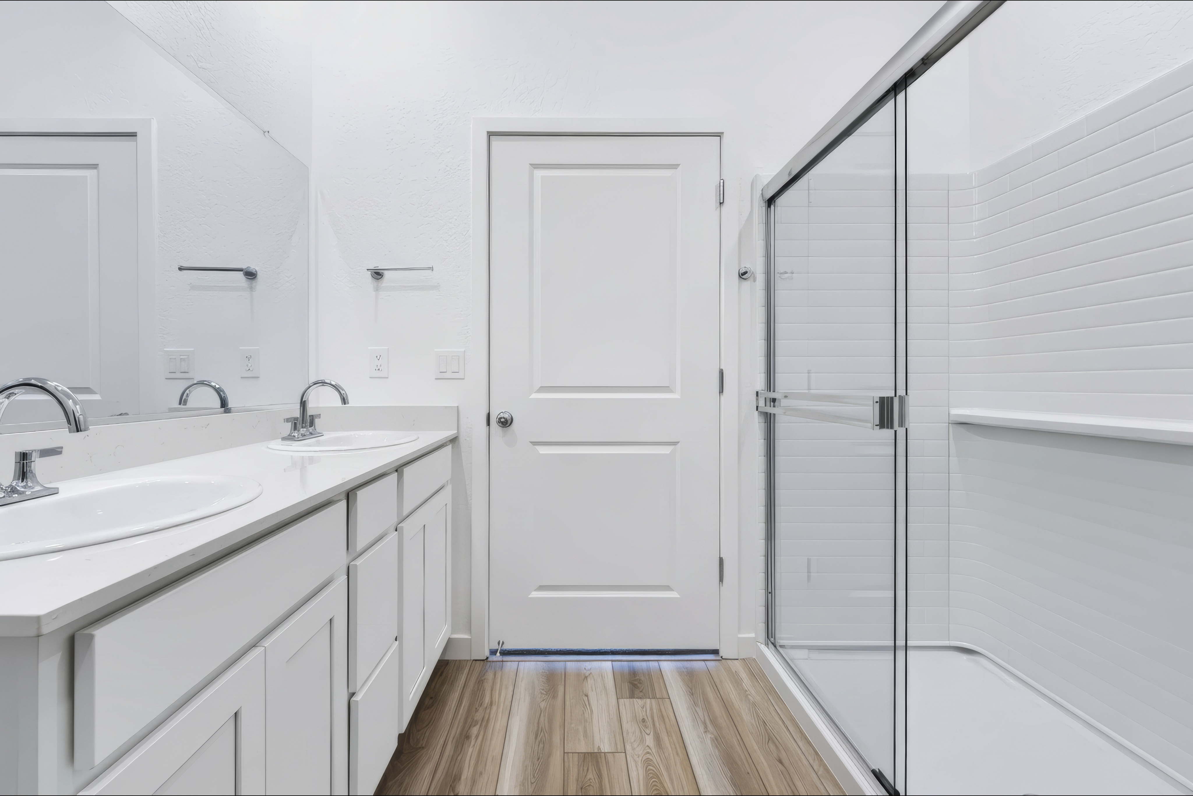 A bathroom with white cabinets.