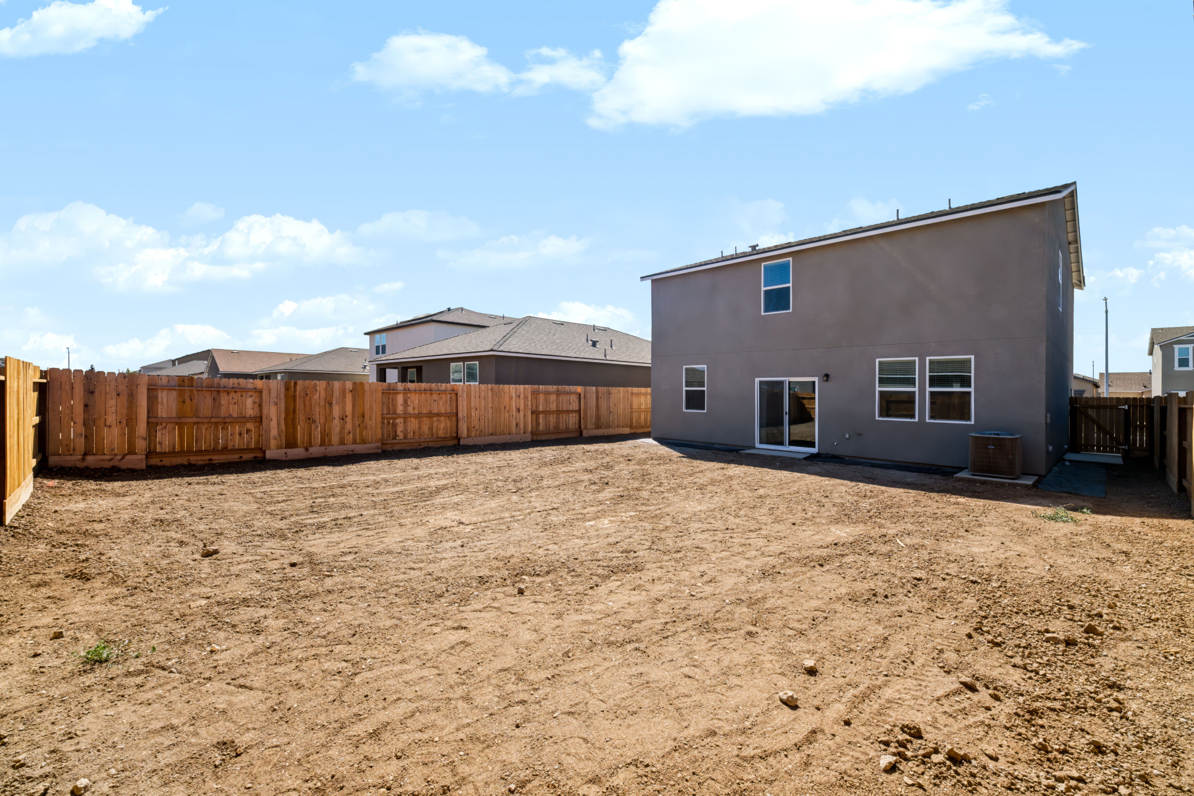 A building in a dirt field.