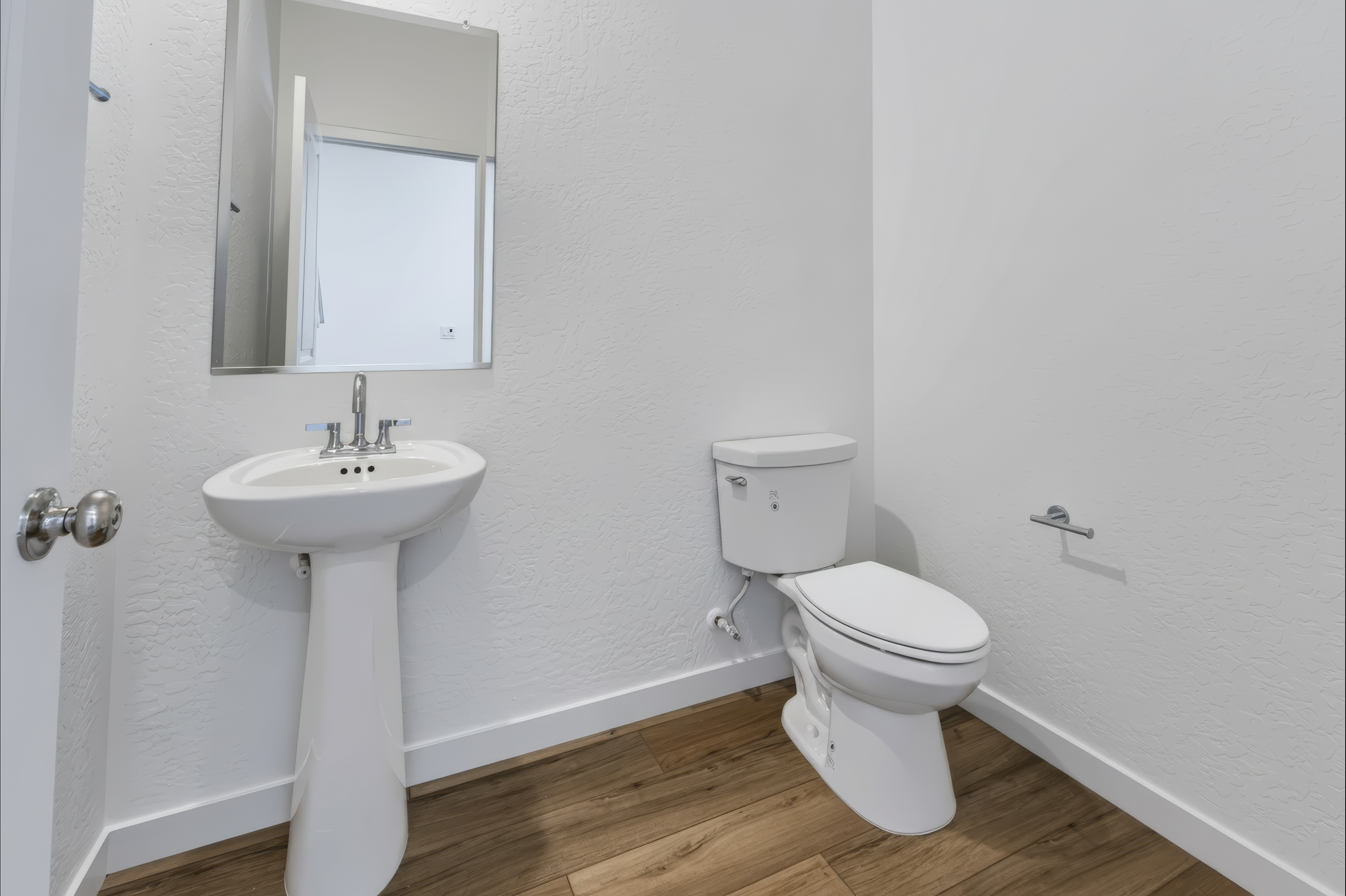 A bathroom with a toilet and sink.