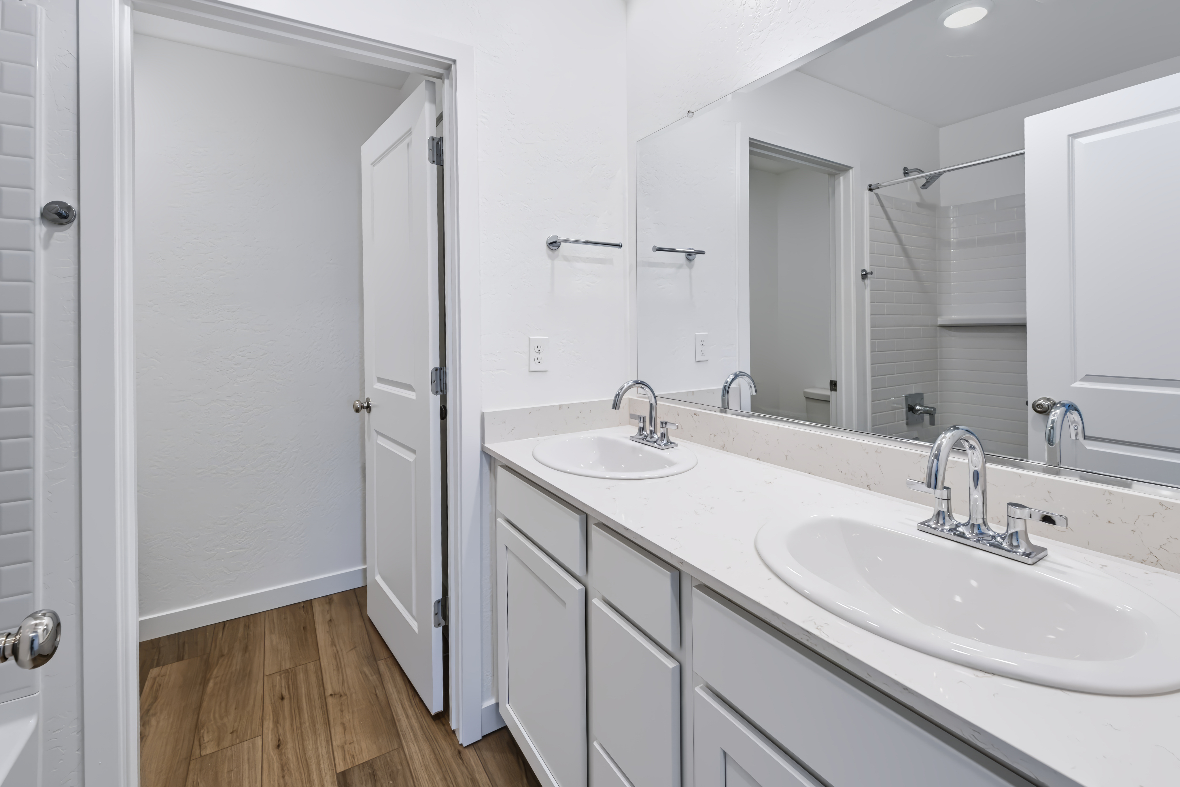 A bathroom with a large mirror.