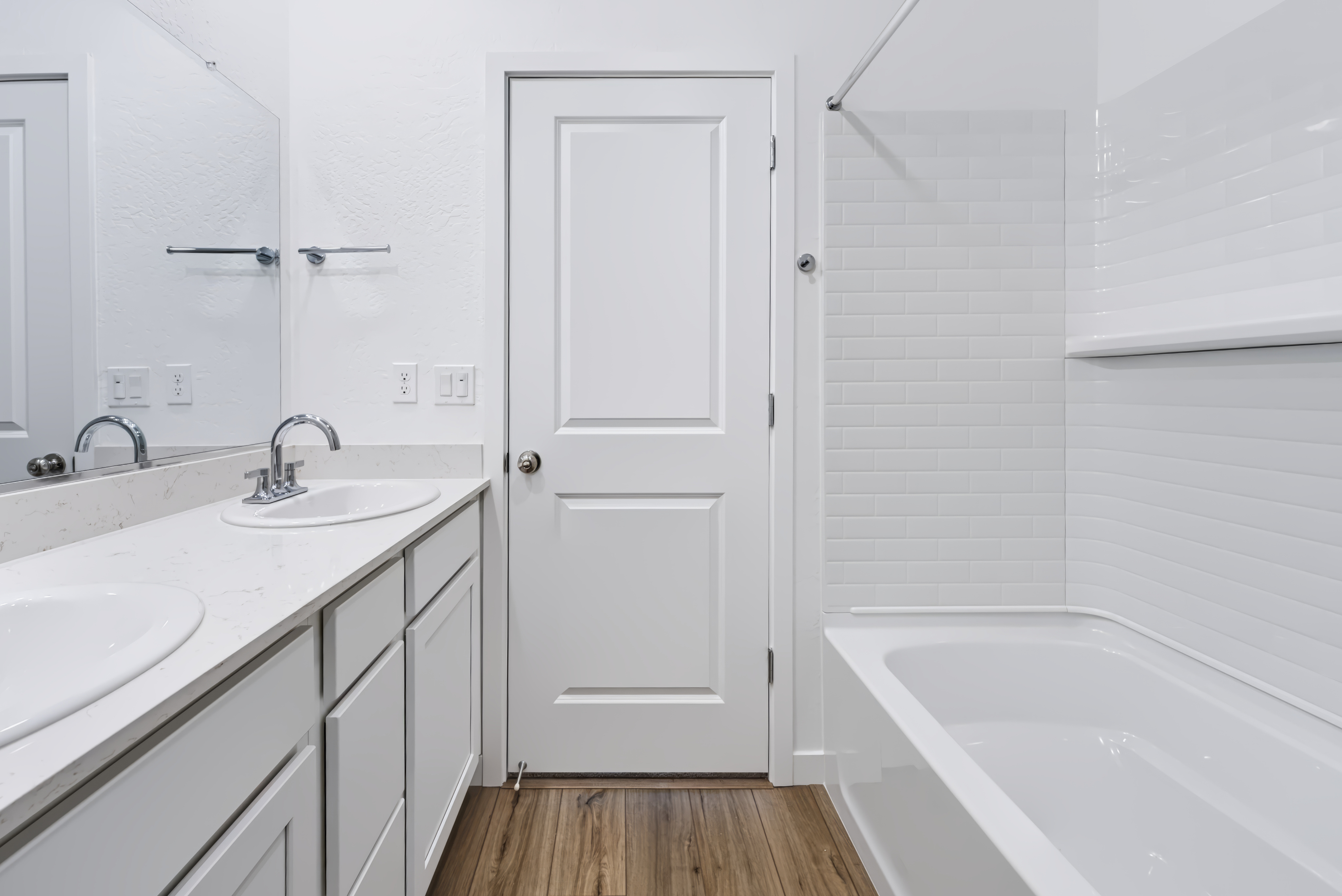 A bathroom with a tub sink and a toilet.