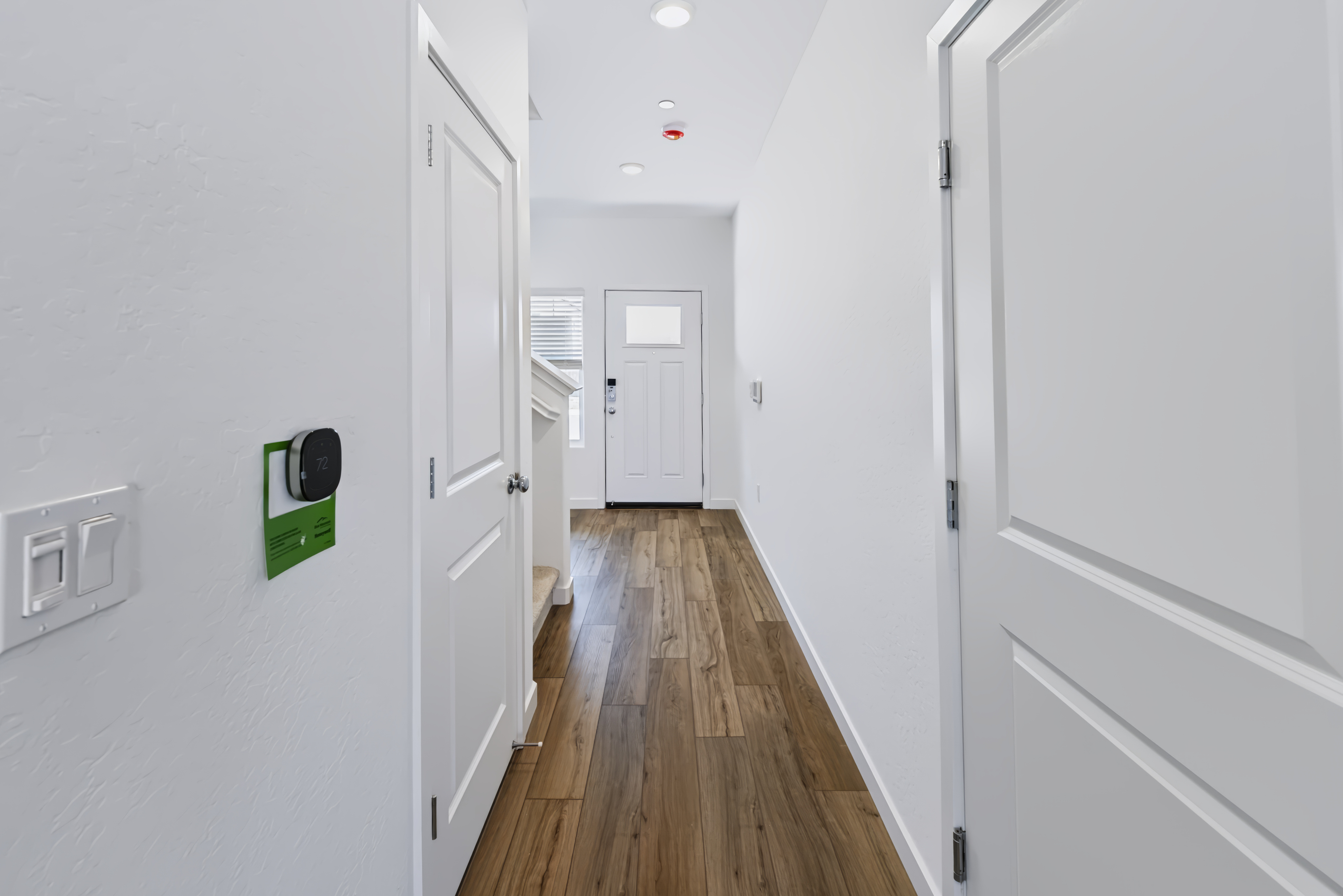 A hallway with white doors.