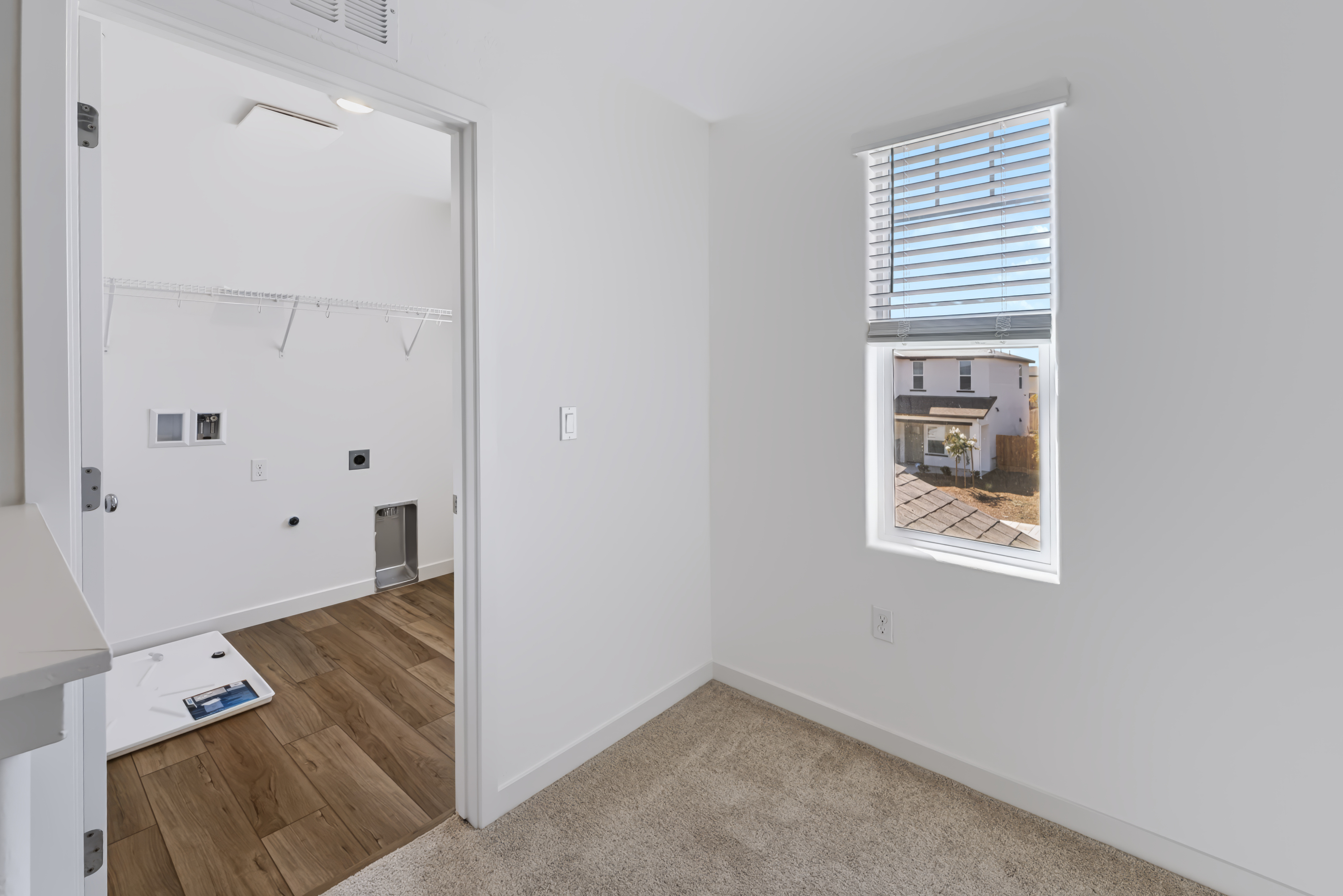 A room with a window and a door with a window.