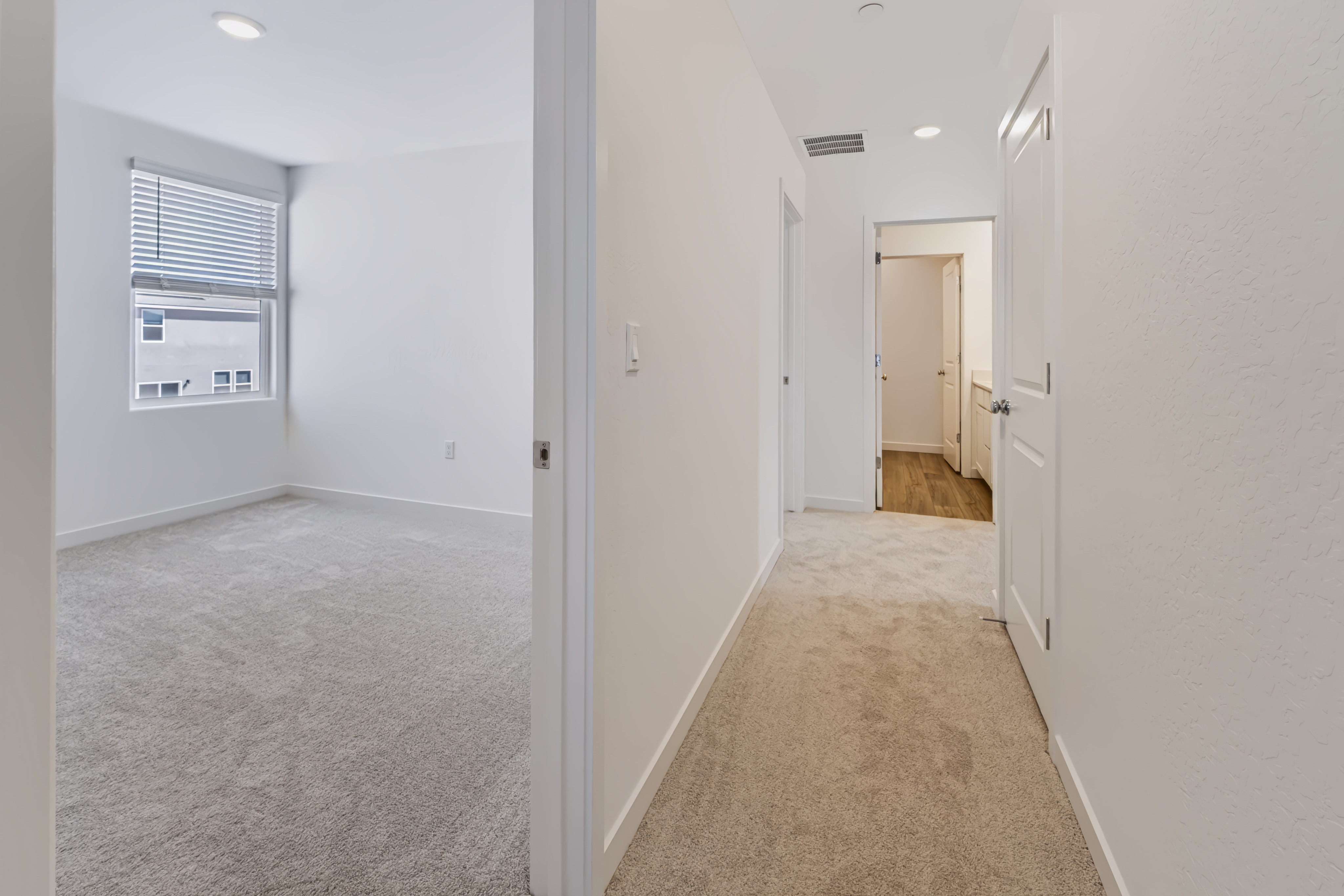 A hallway with white doors.