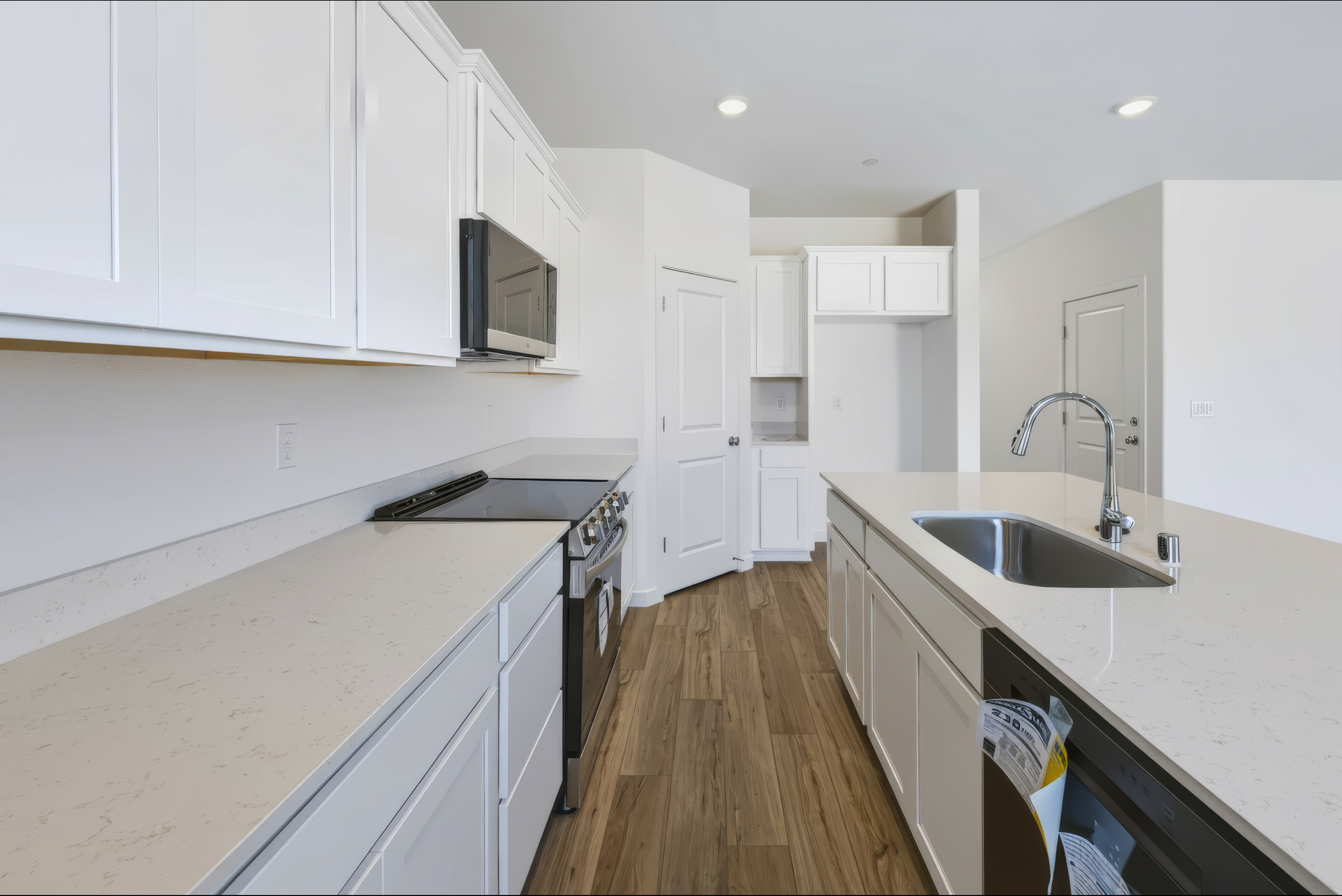 A kitchen with white cabinets.