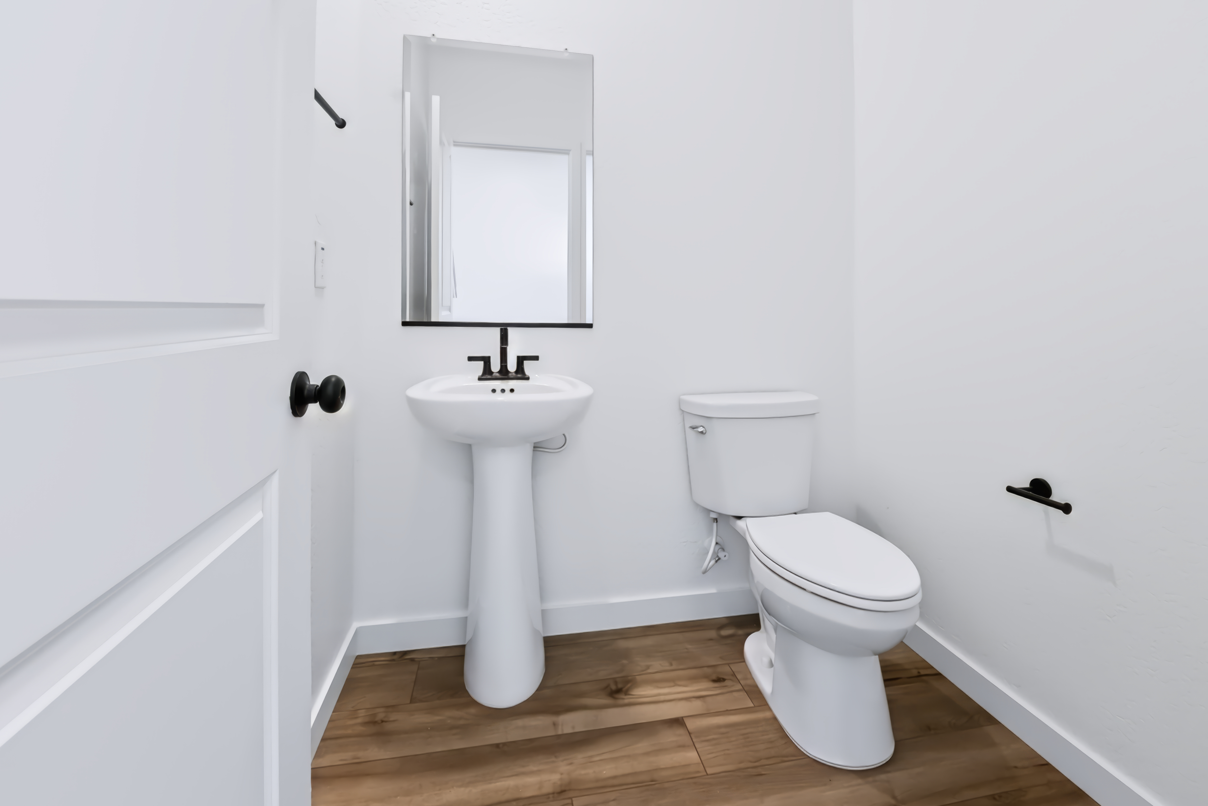 A bathroom with a toilet and sink.
