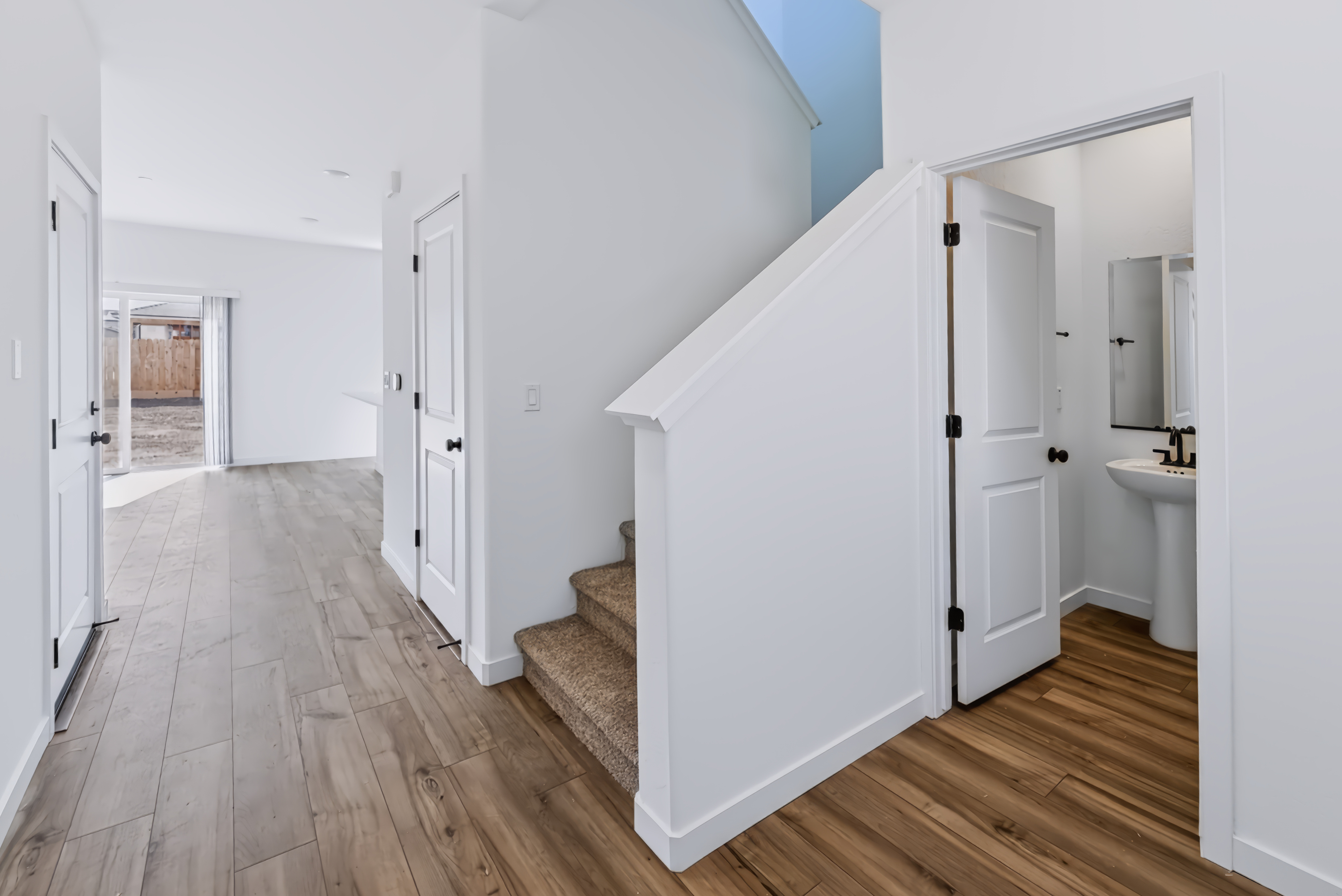 A bathroom with white cabinets.