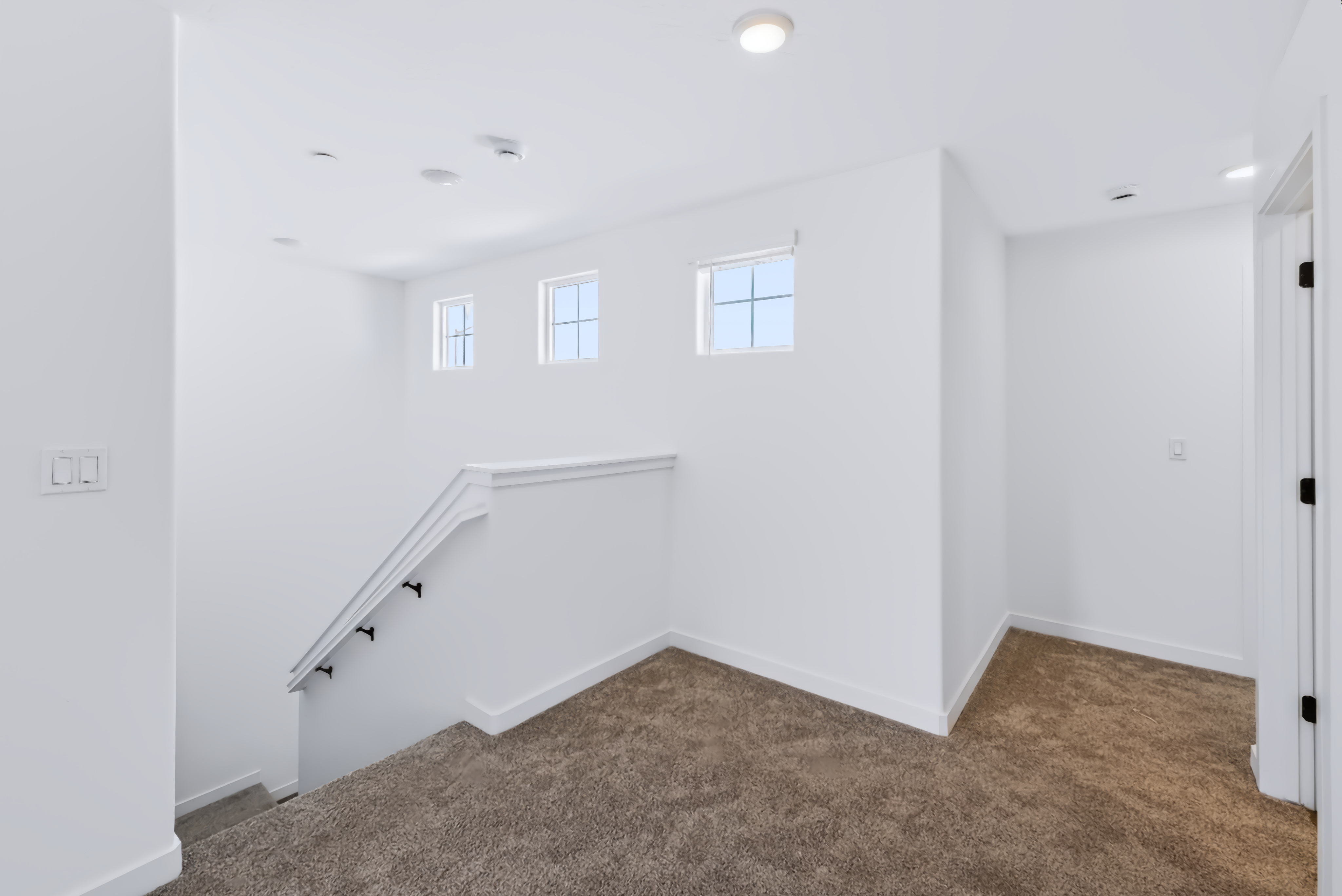 A room with a staircase and a door.