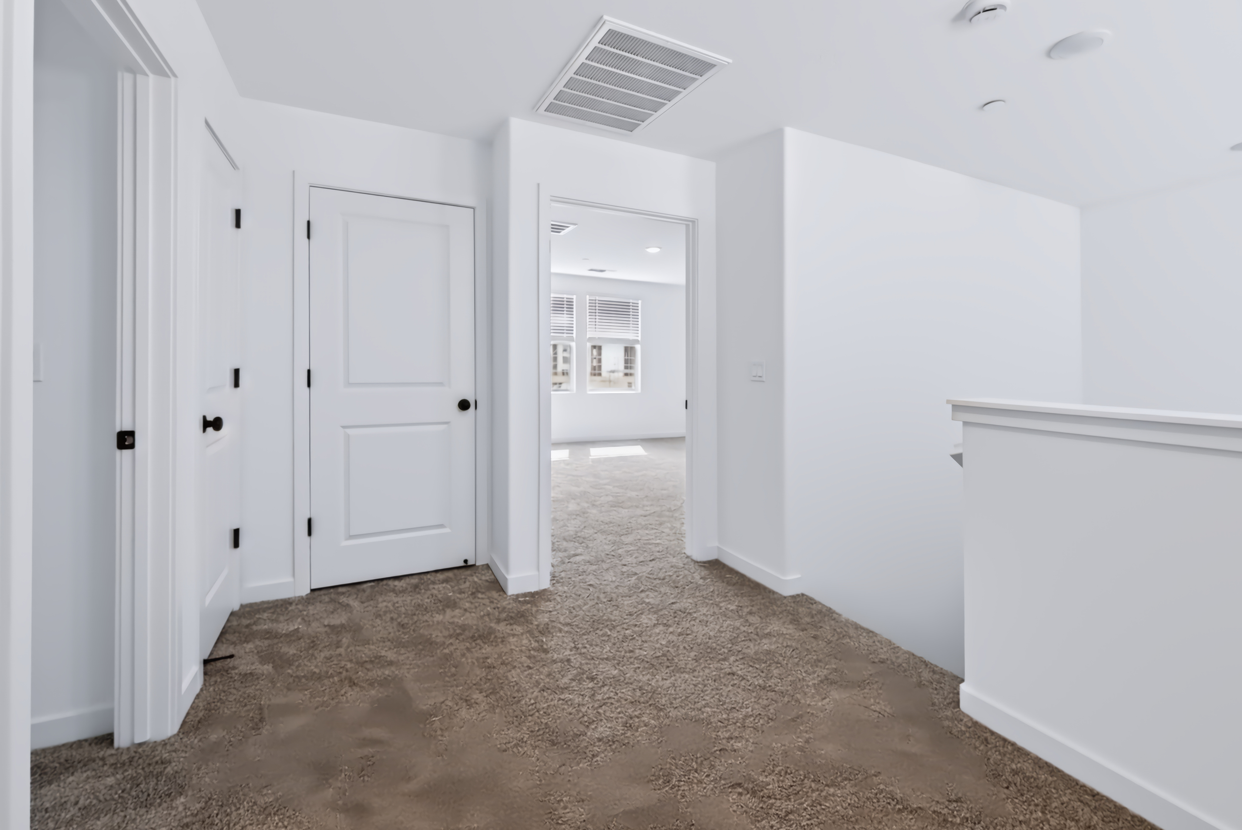 A hallway with white doors.
