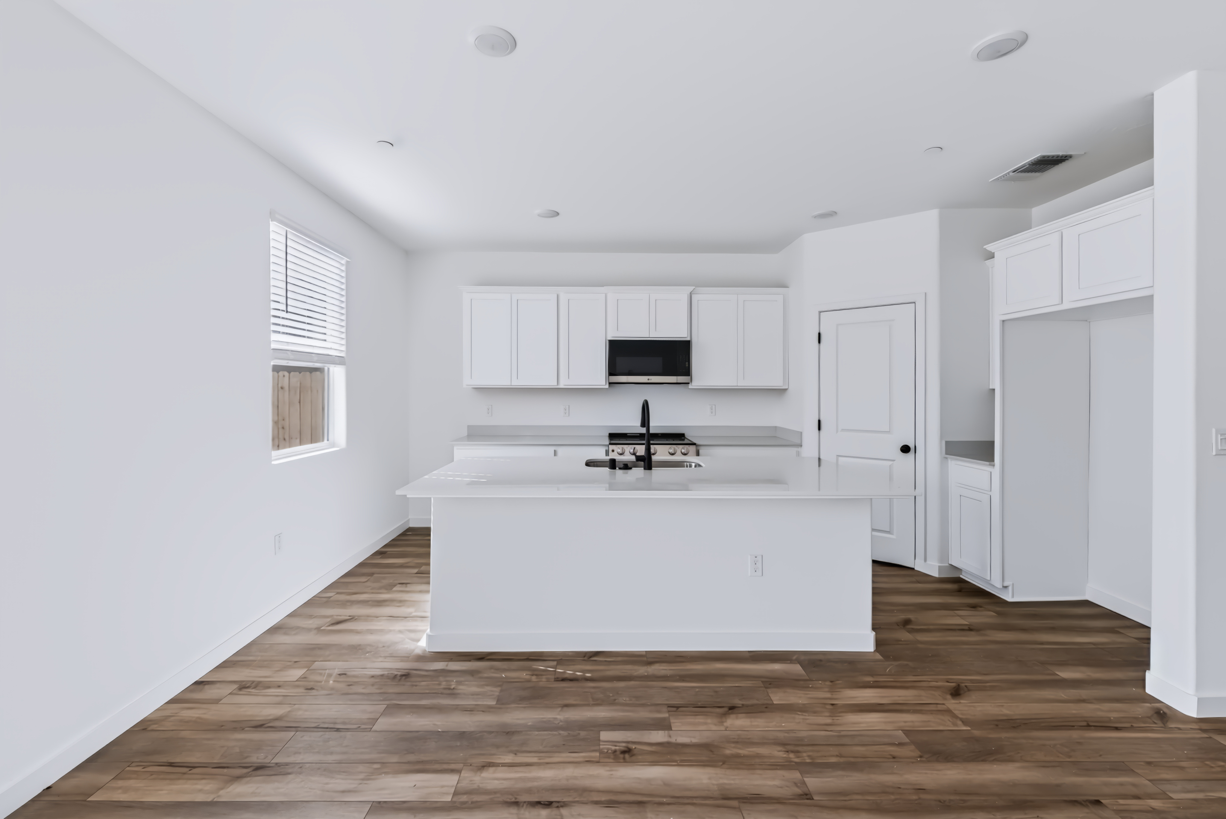 A white kitchen with white cabinets.