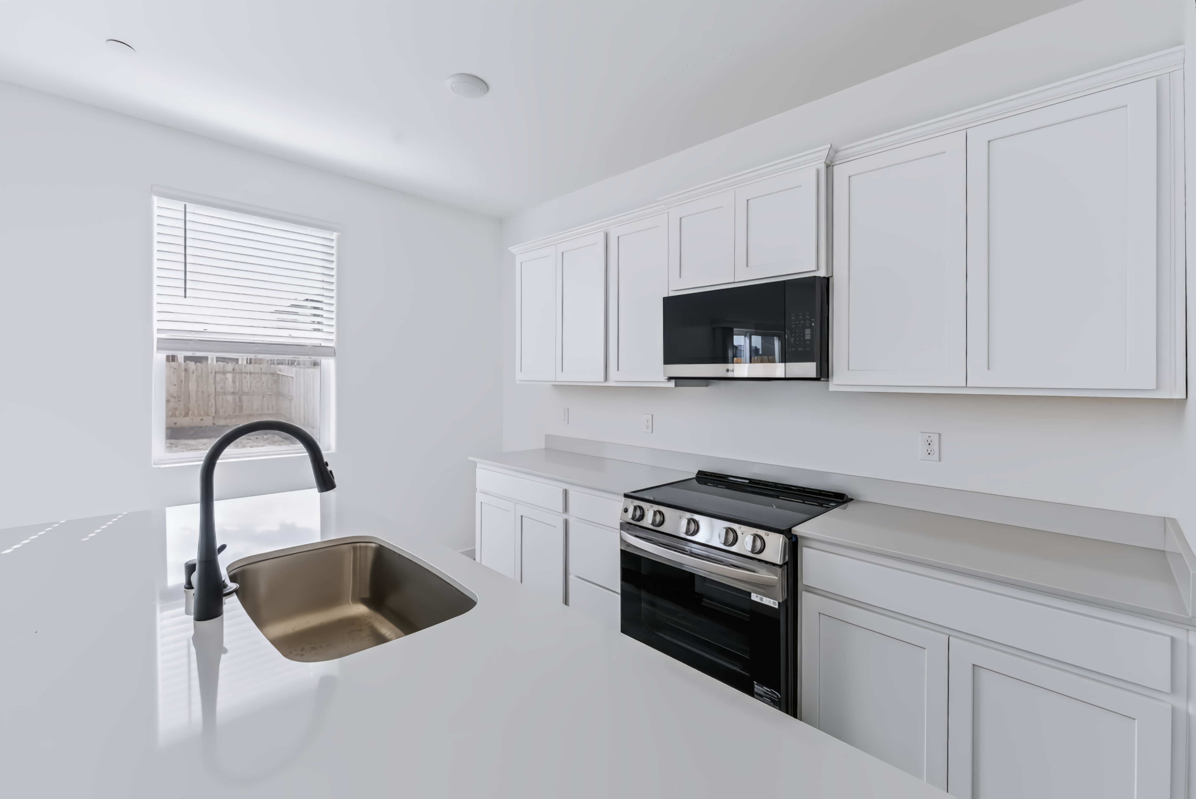 A kitchen with white cabinets.