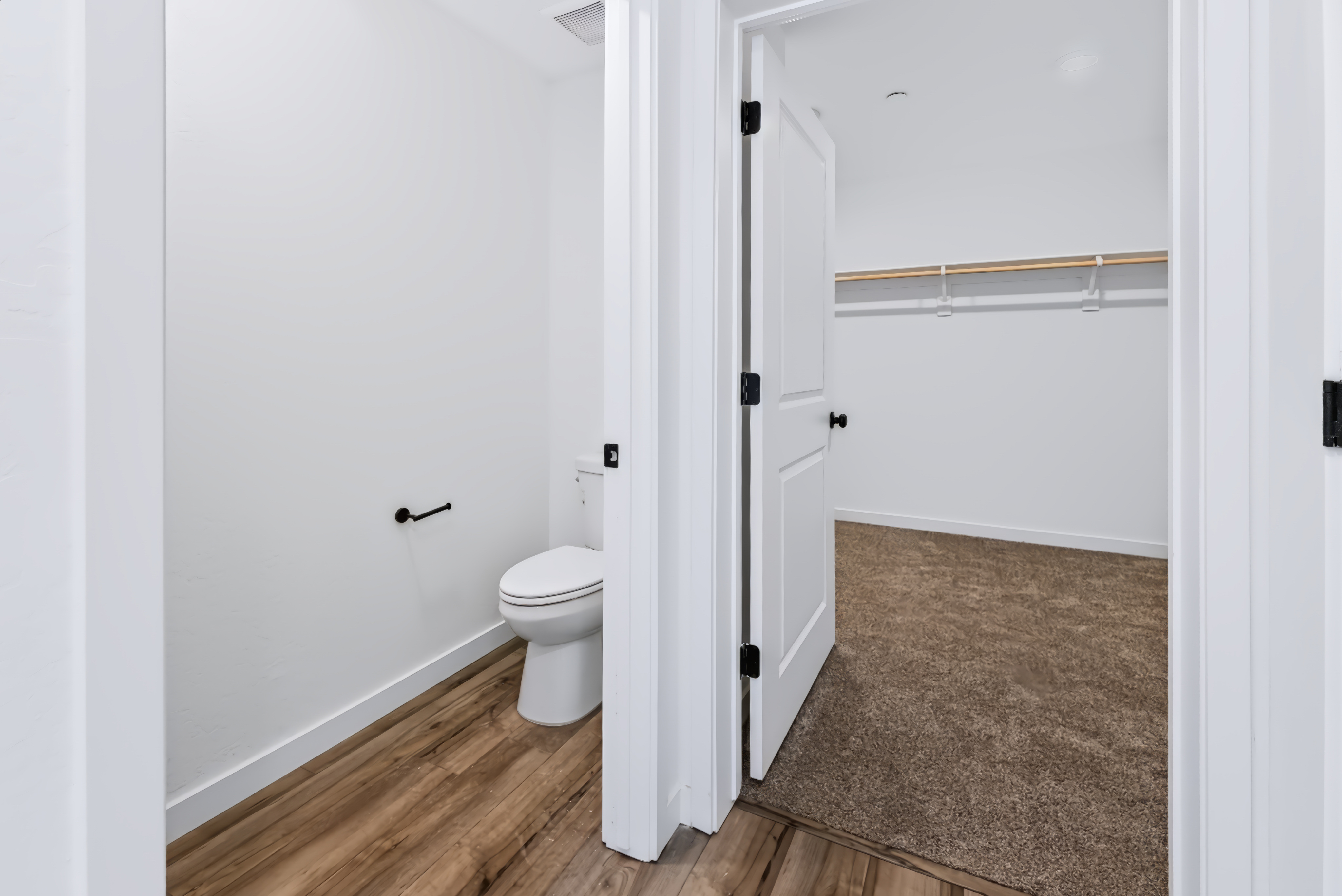 A bathroom with a toilet and a shower unit.