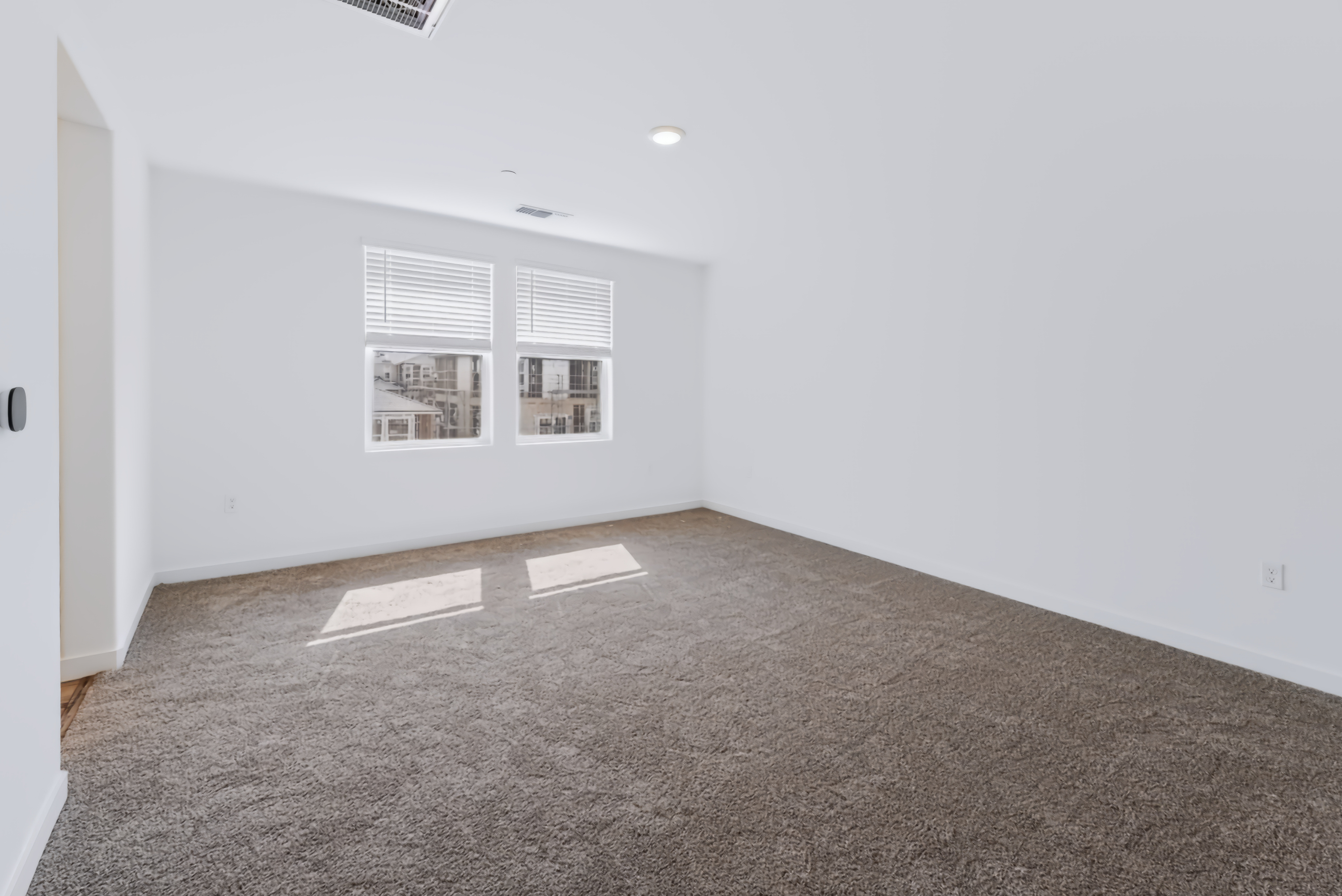 A room with a carpet and a rug.