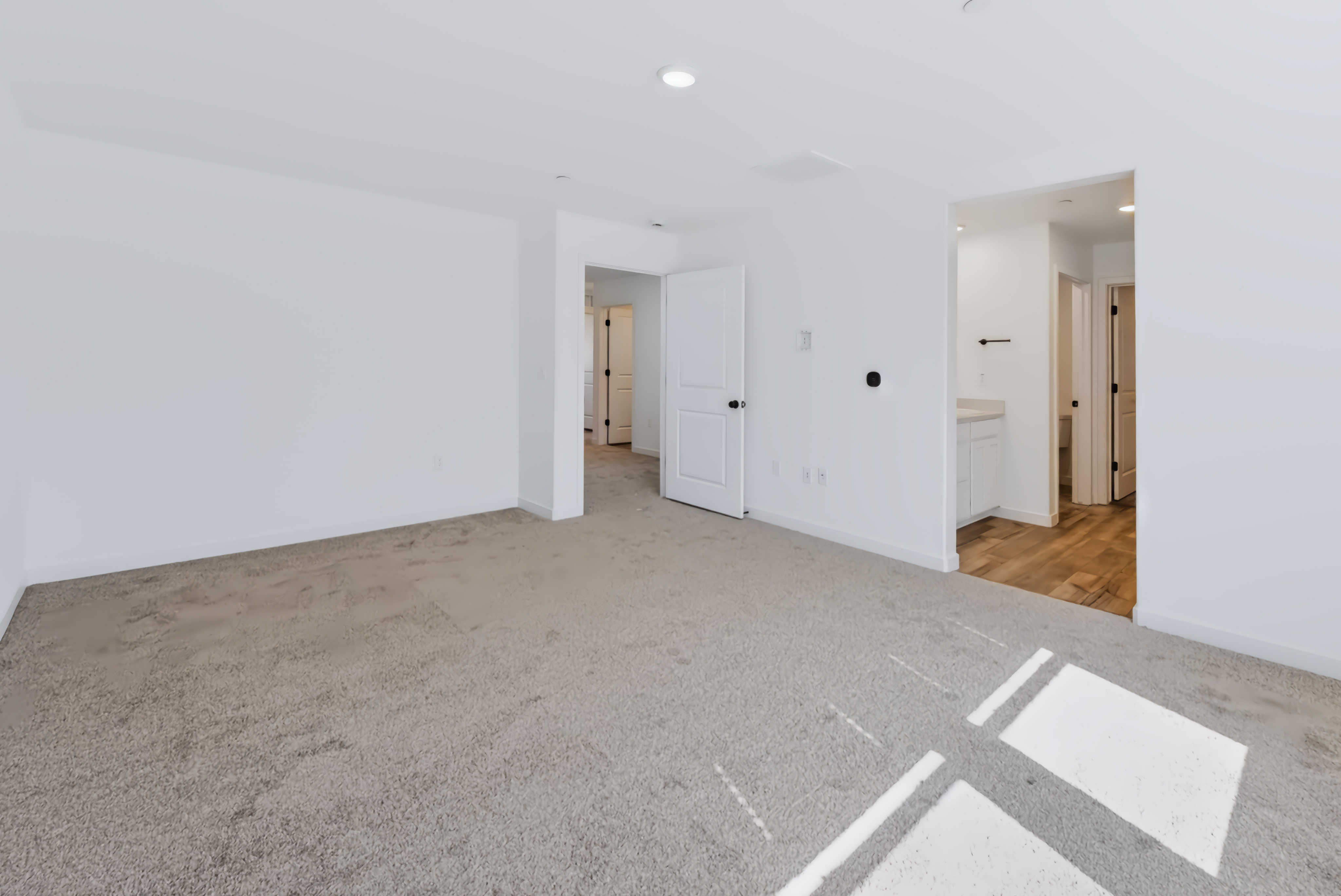 A hallway with white walls.