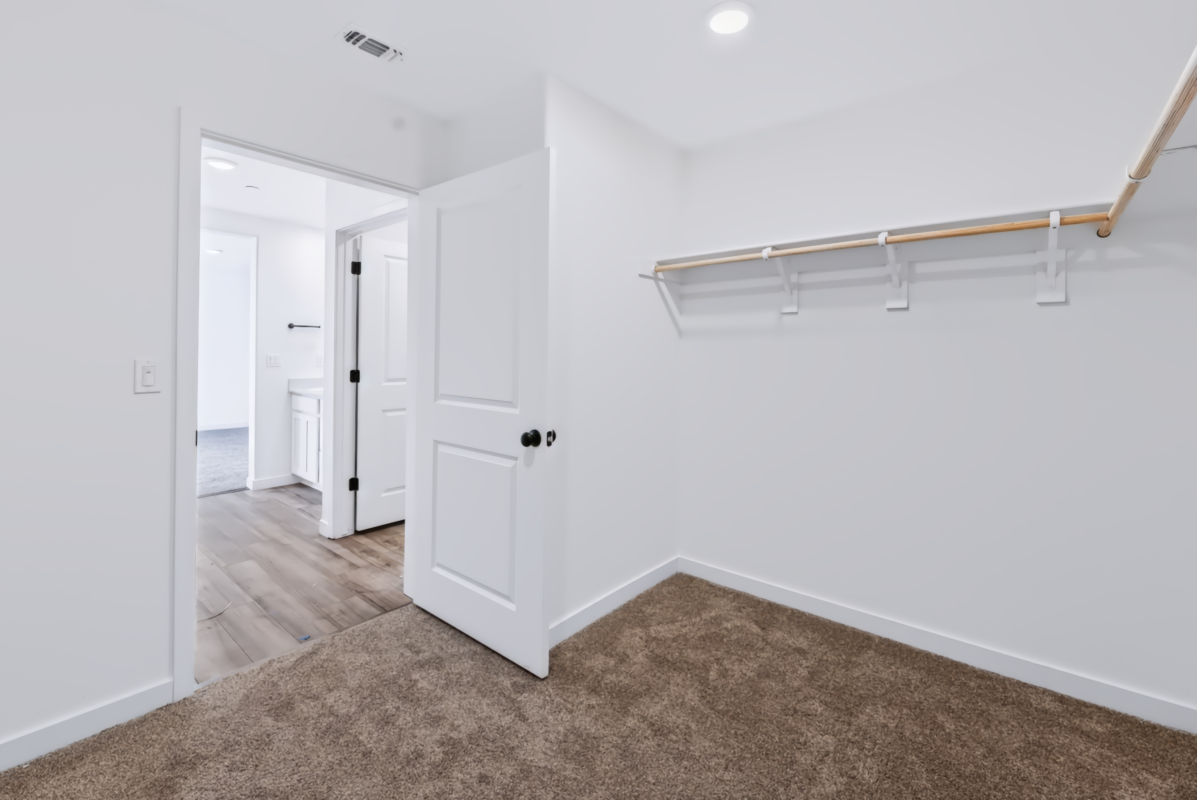 A hallway with white walls.