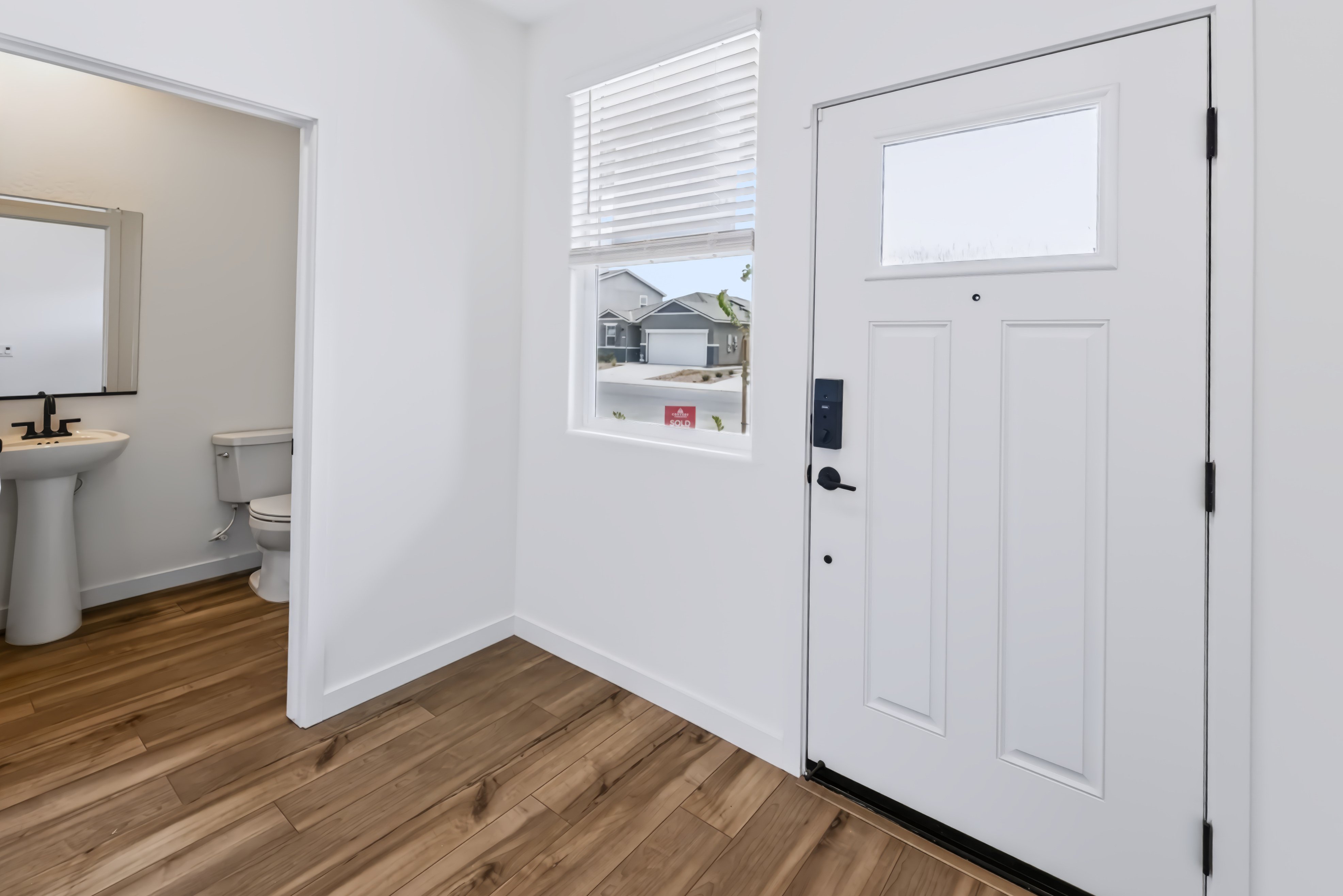 A bathroom with a wood floor.