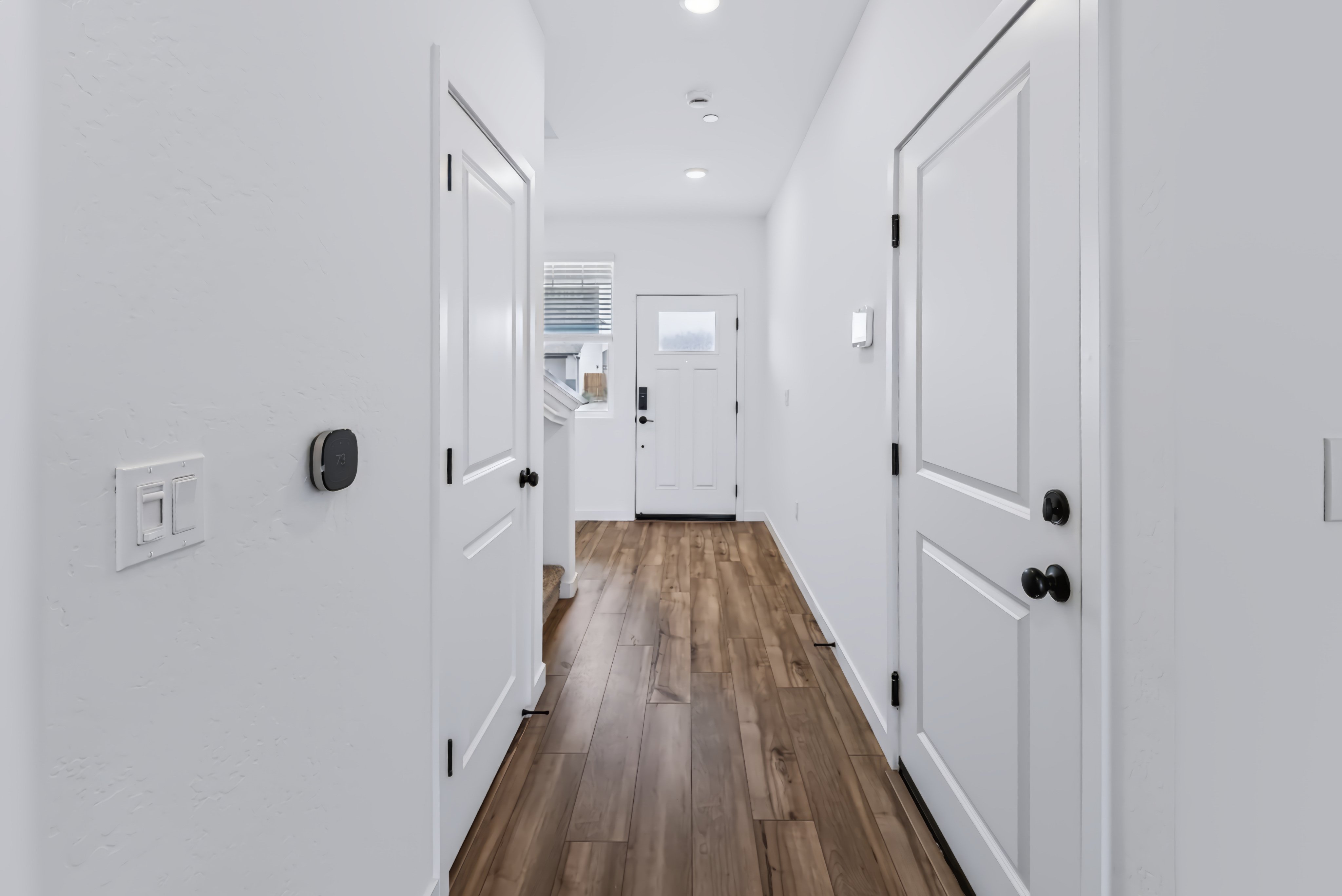 A hallway with white doors.