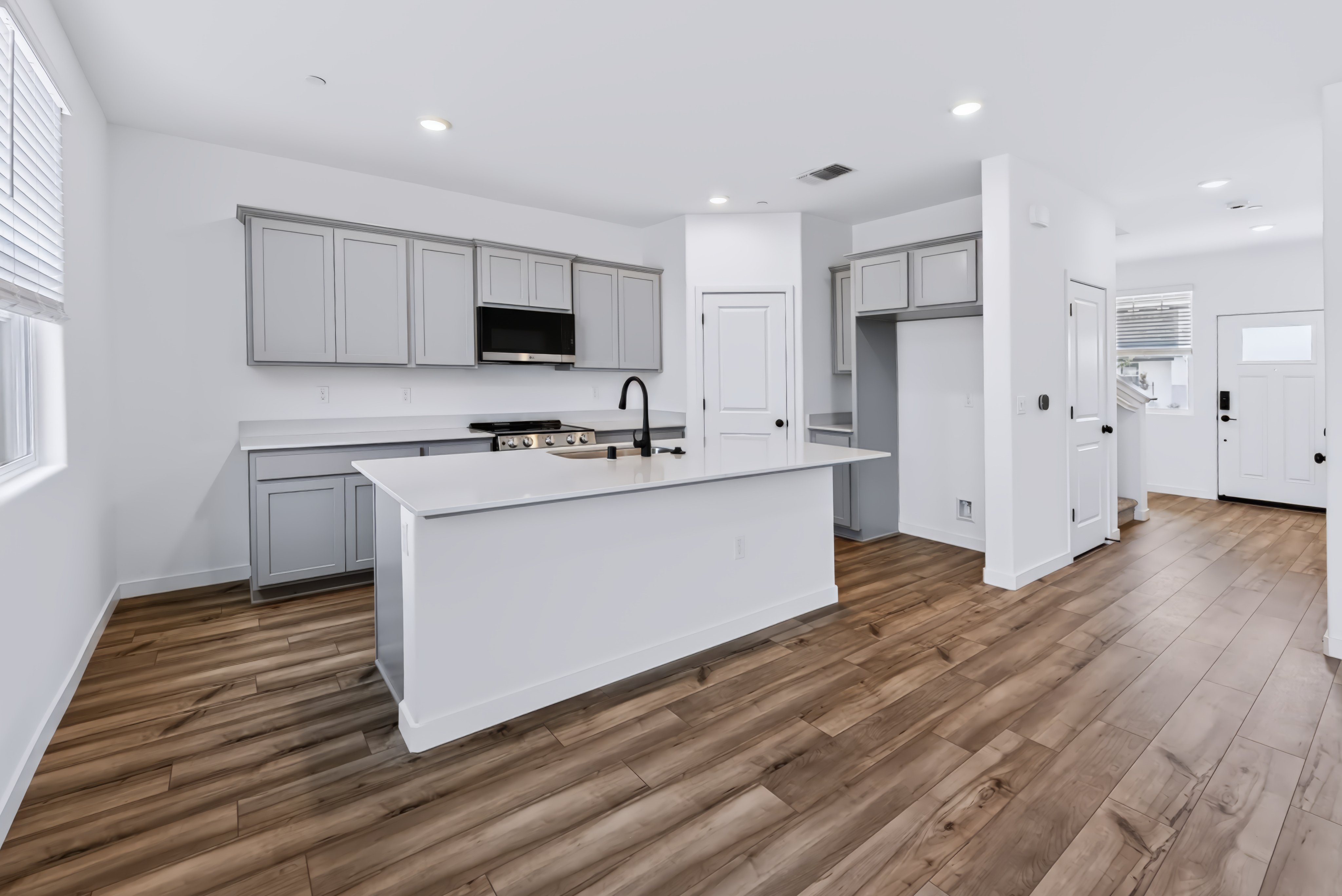 A kitchen with white cabinets.
