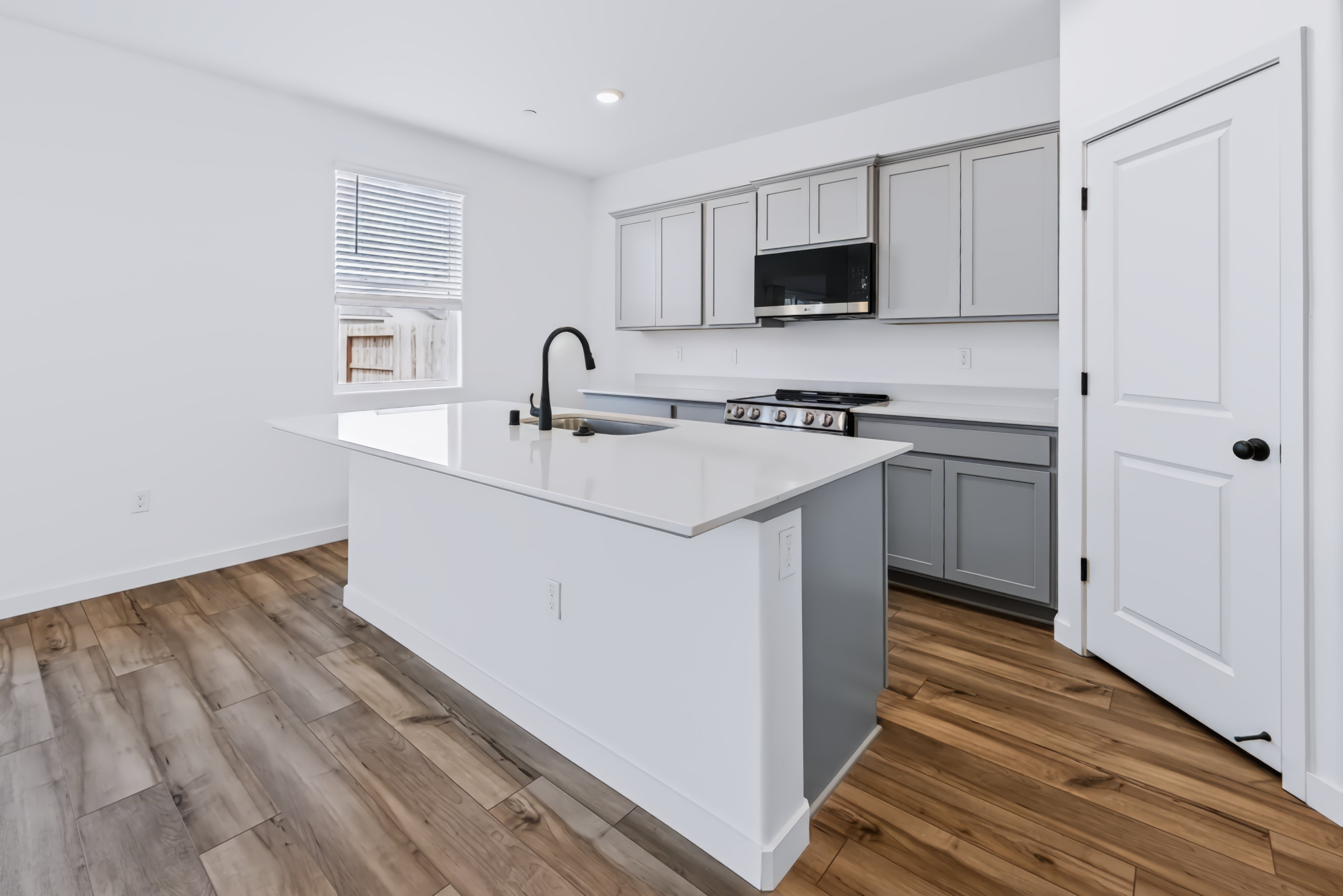 A kitchen with white cabinets.