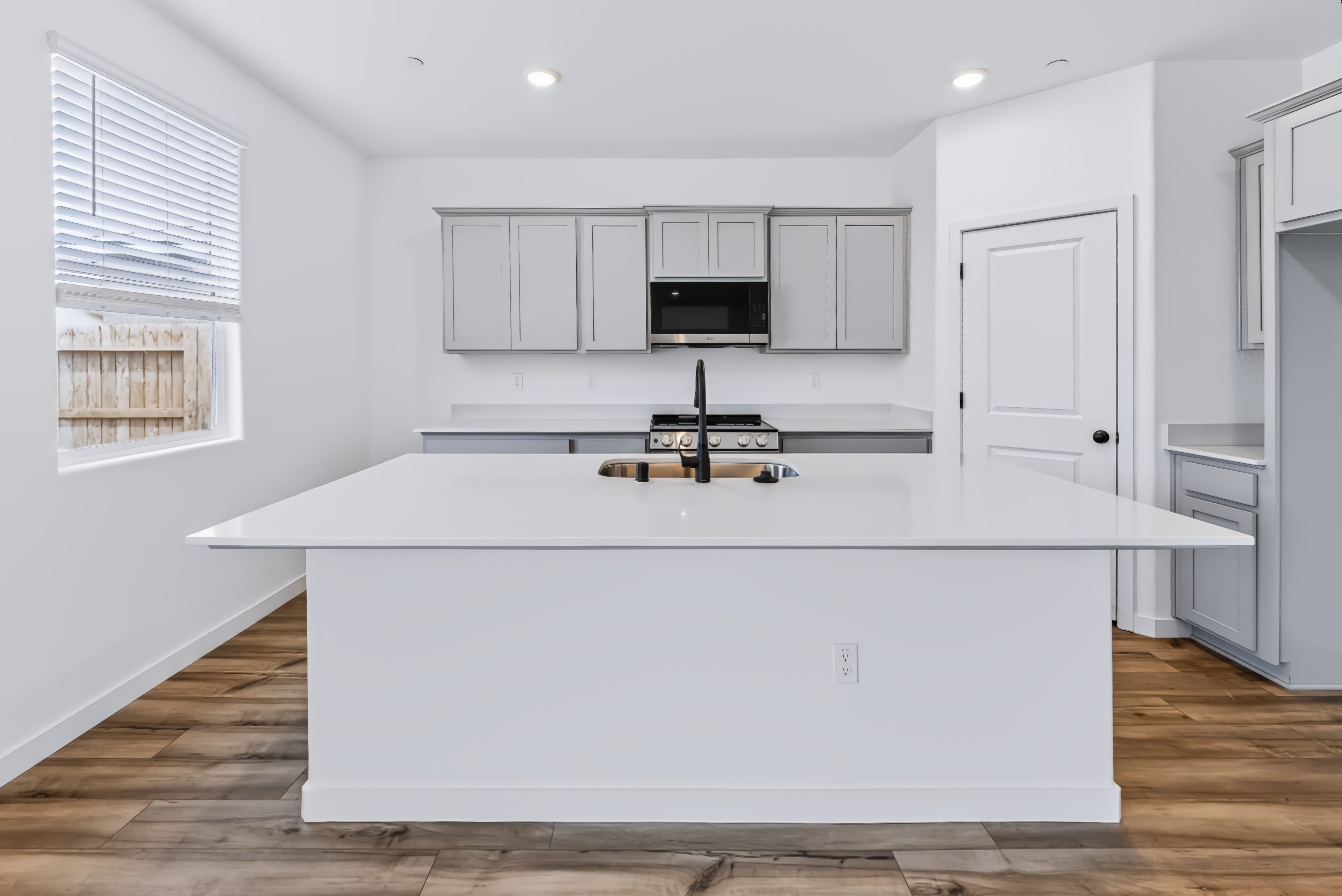 A kitchen with white cabinets.