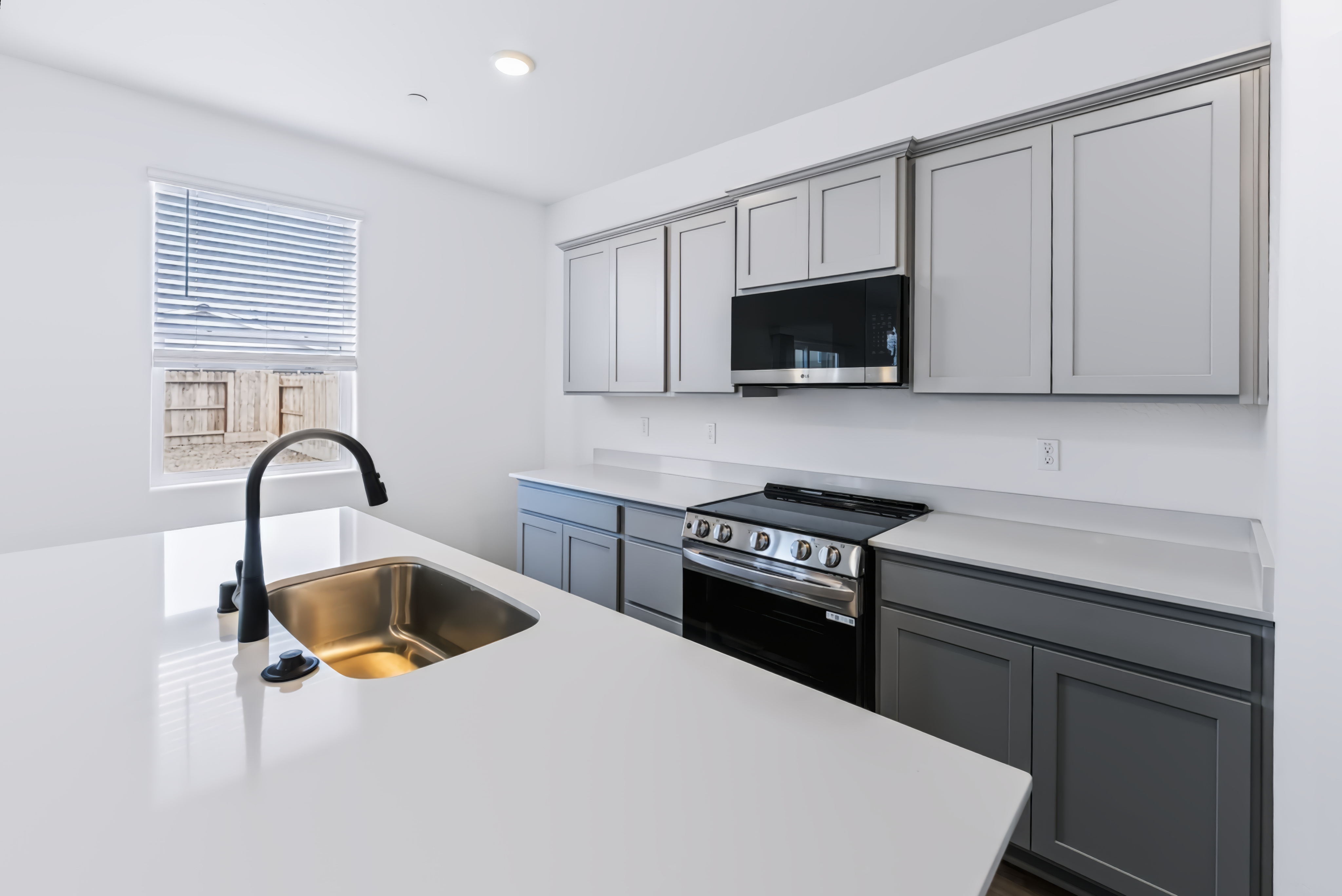 A kitchen with white cabinets.