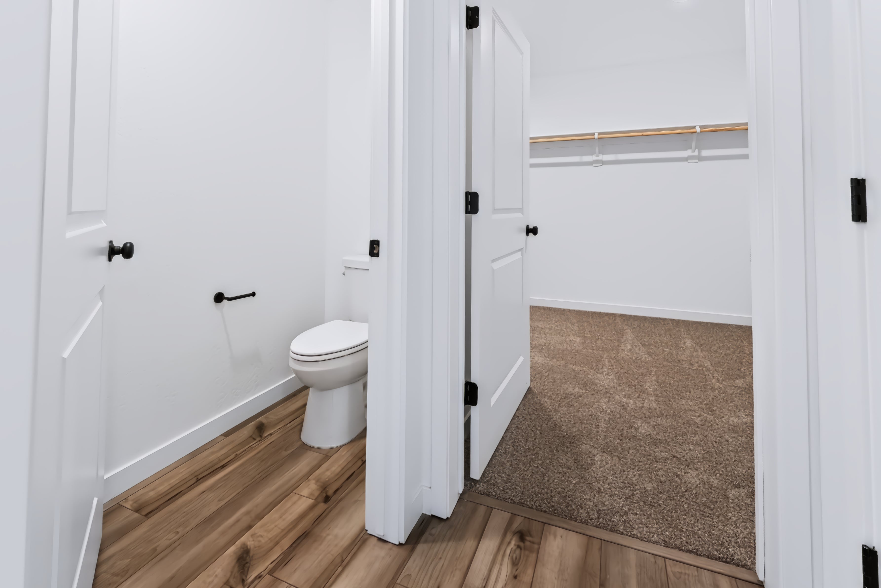 A bathroom with a toilet and a rug.