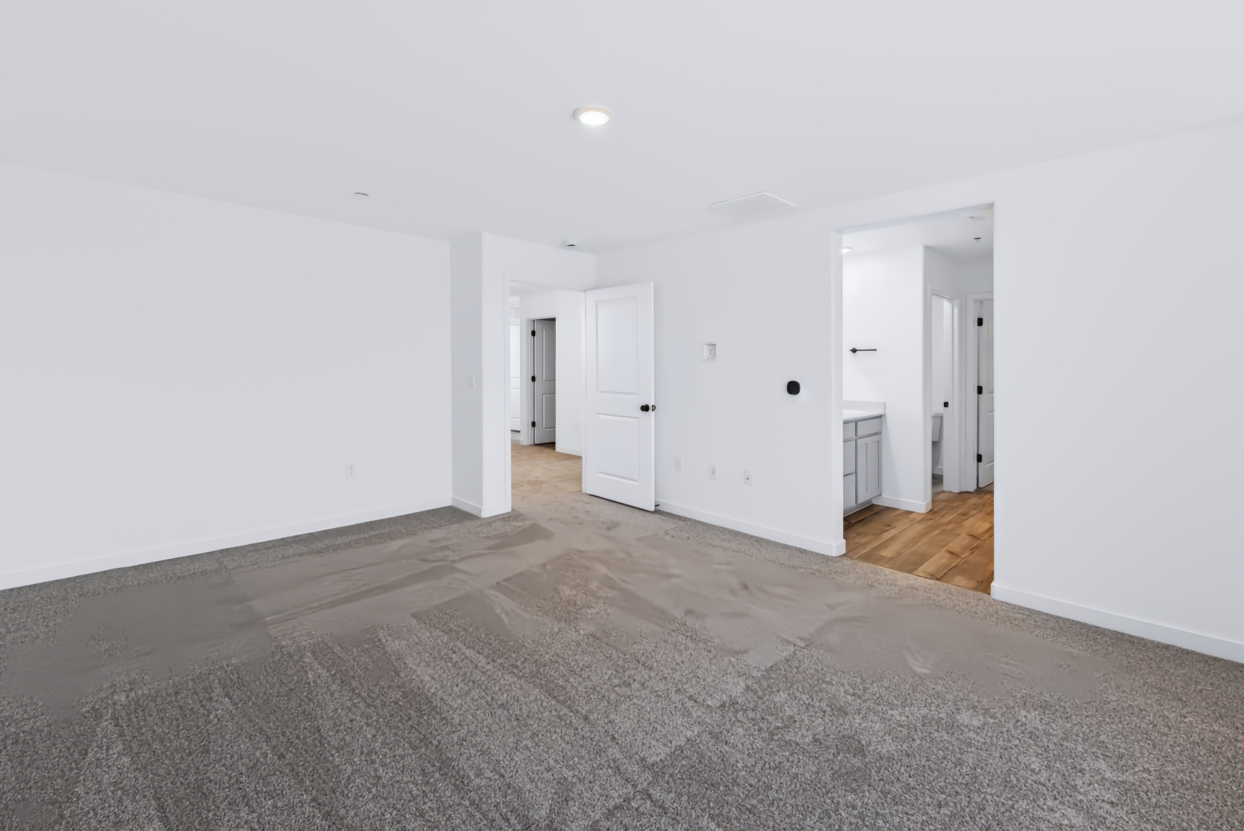 A long hallway with white walls.