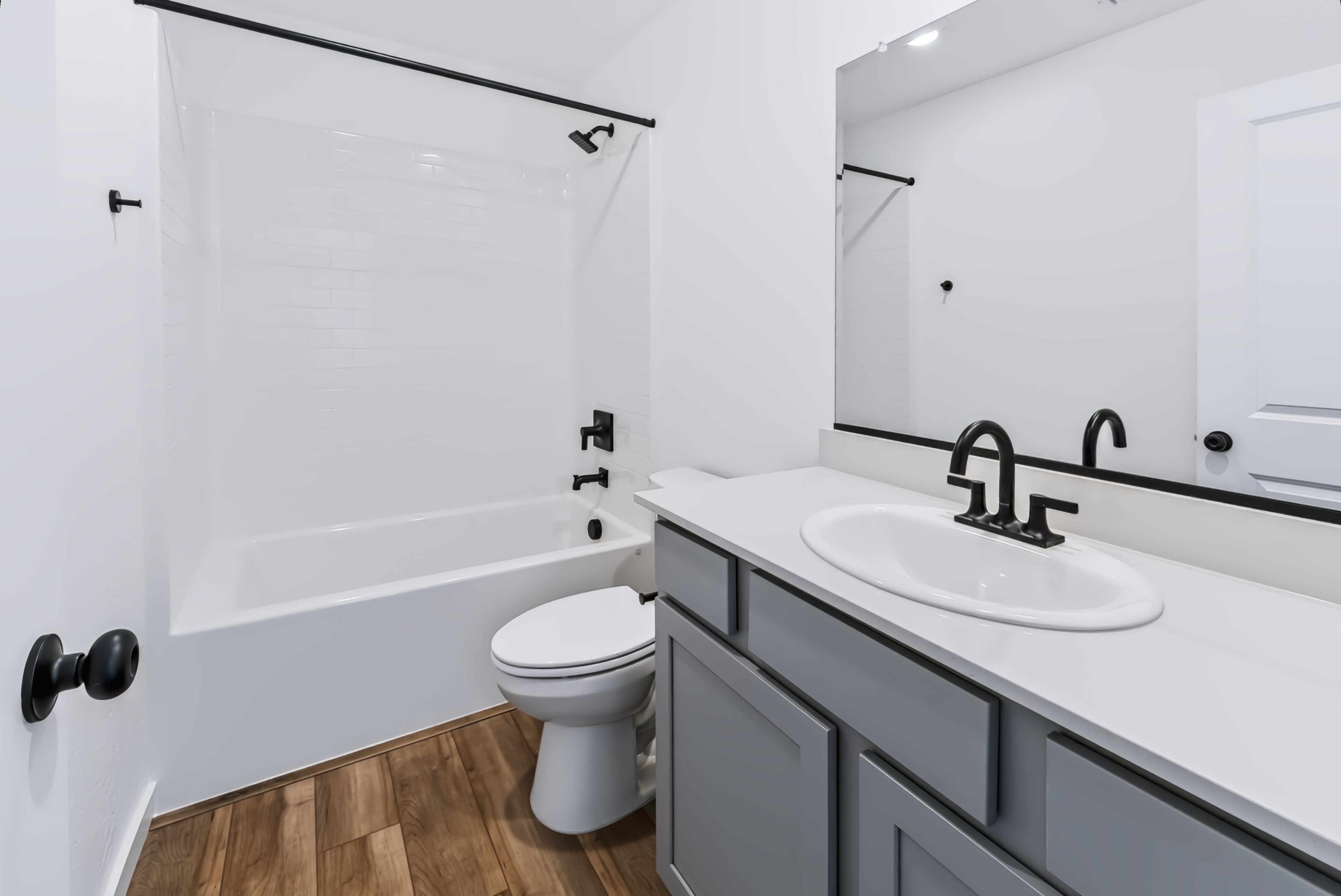 A bathroom with a sink toilet and bathtub.