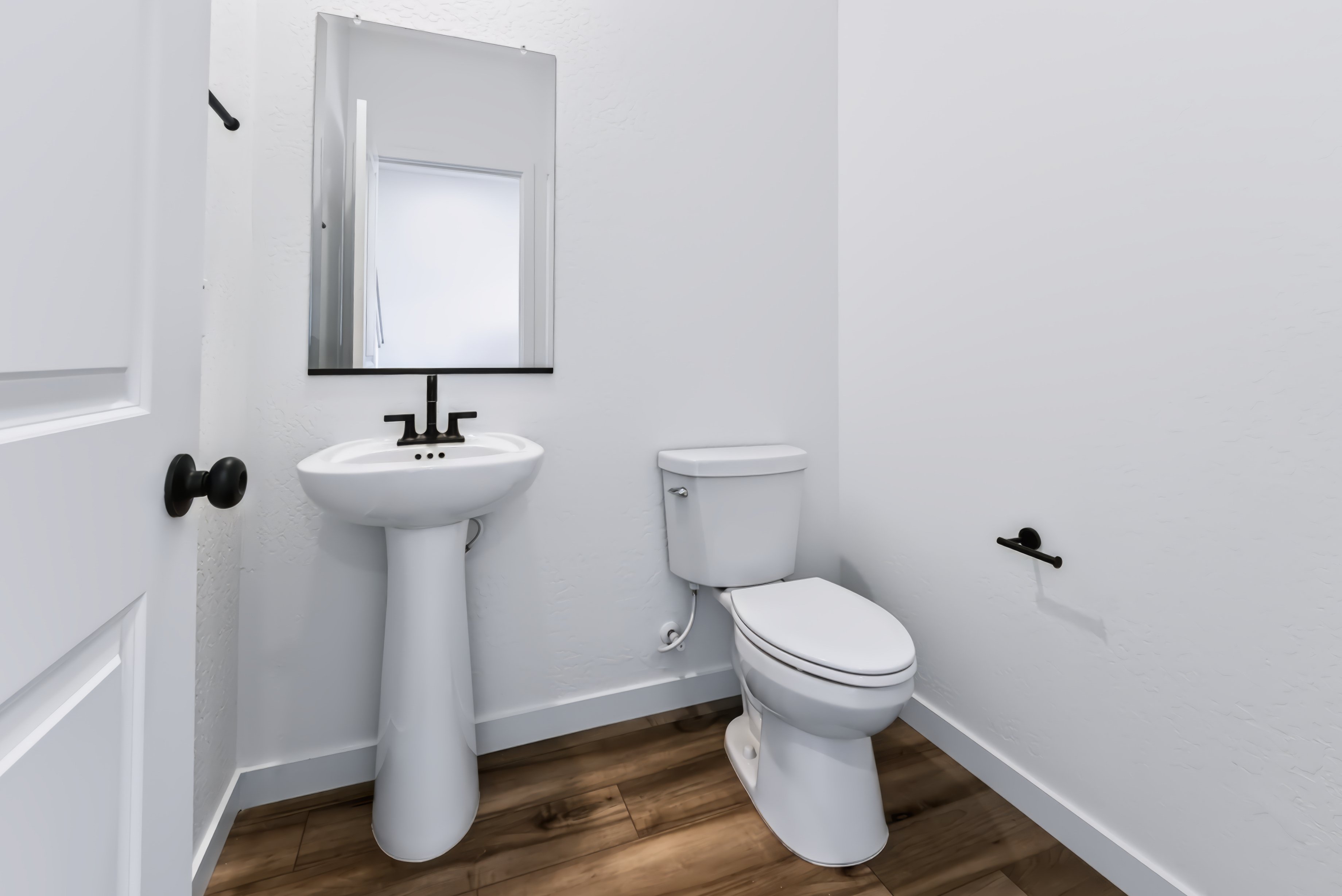 A bathroom with a toilet and sink.