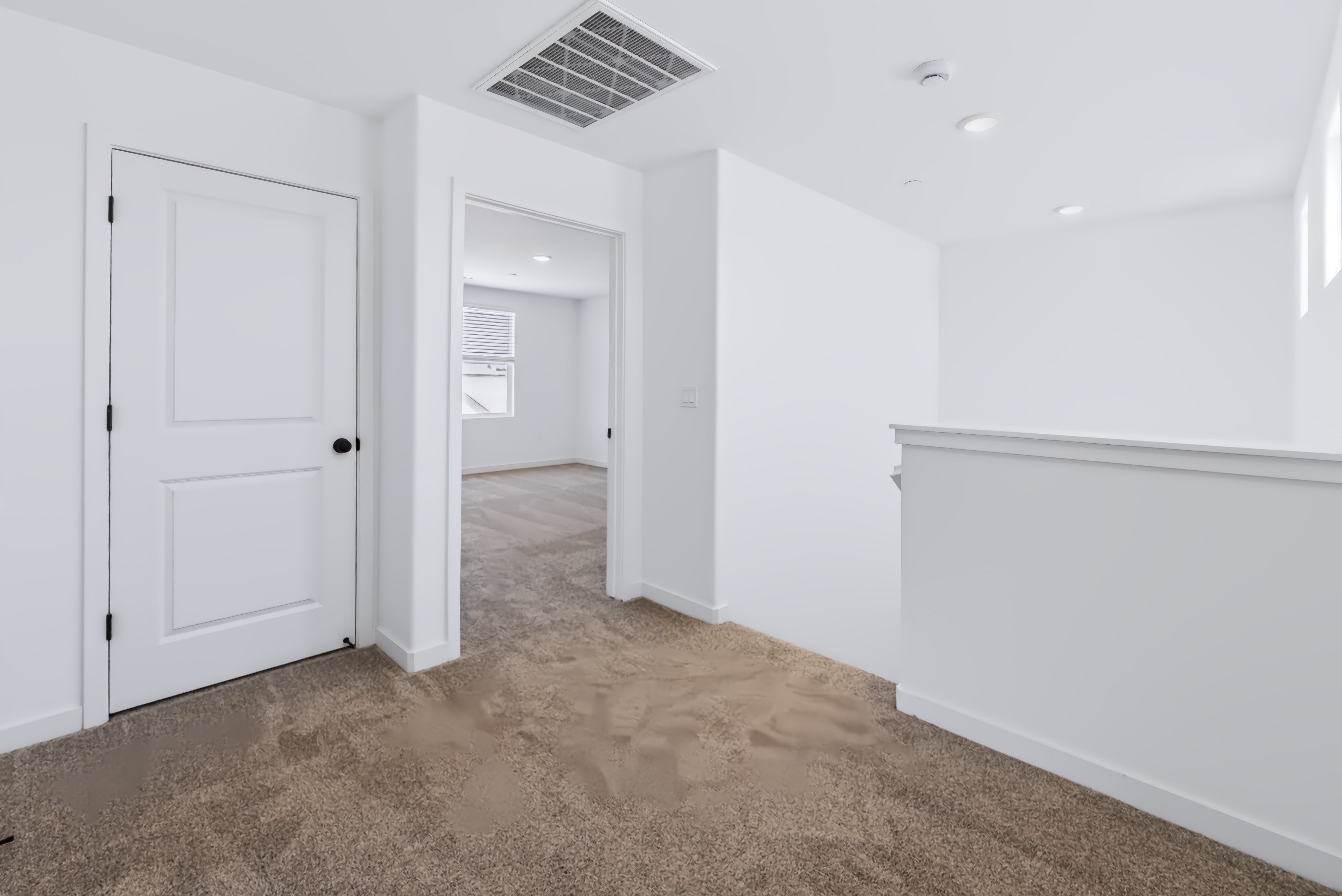 A hallway with white doors.