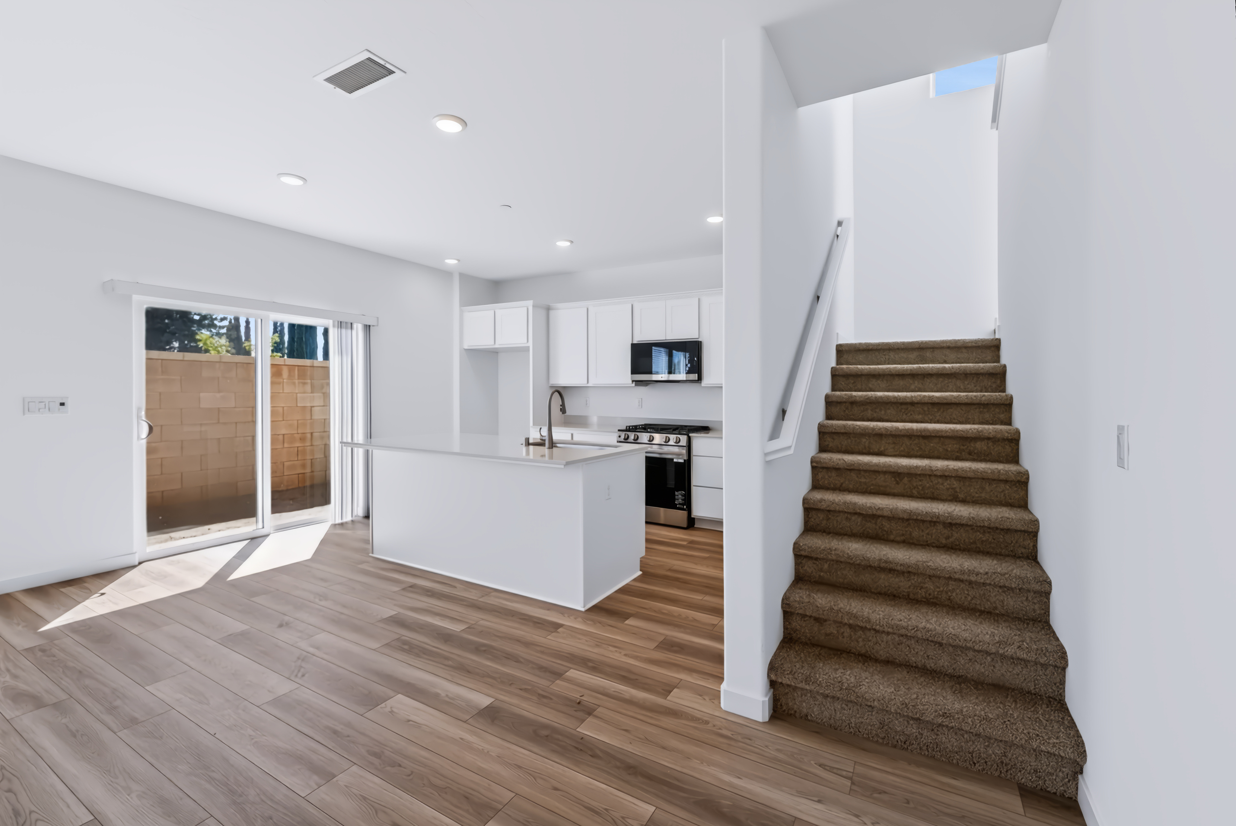 A large kitchen with wooden floors.
